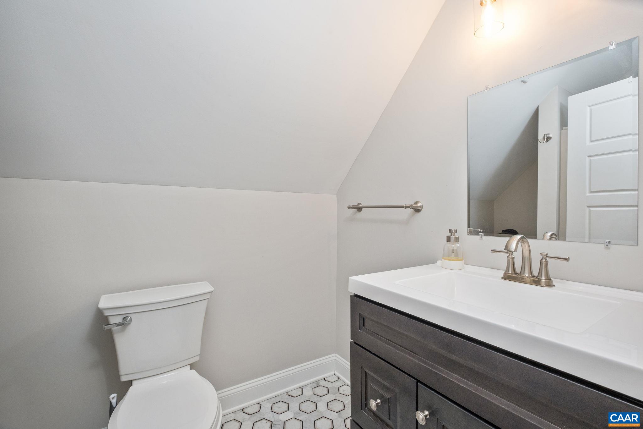 This full en suite bathroom offers a second primary suite option.
