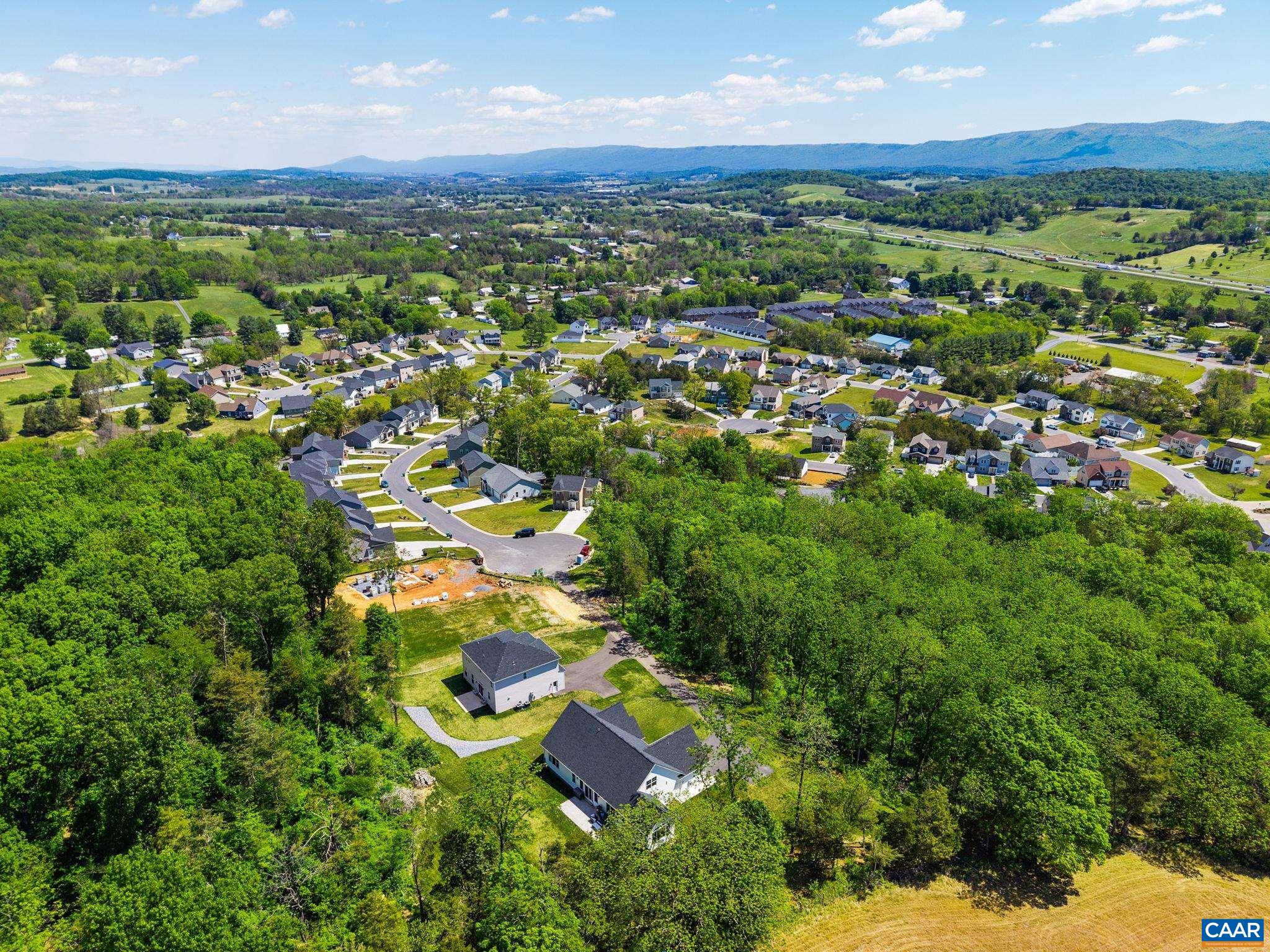 The drone is just over the neighboring field, looking to the home and subdivision below.