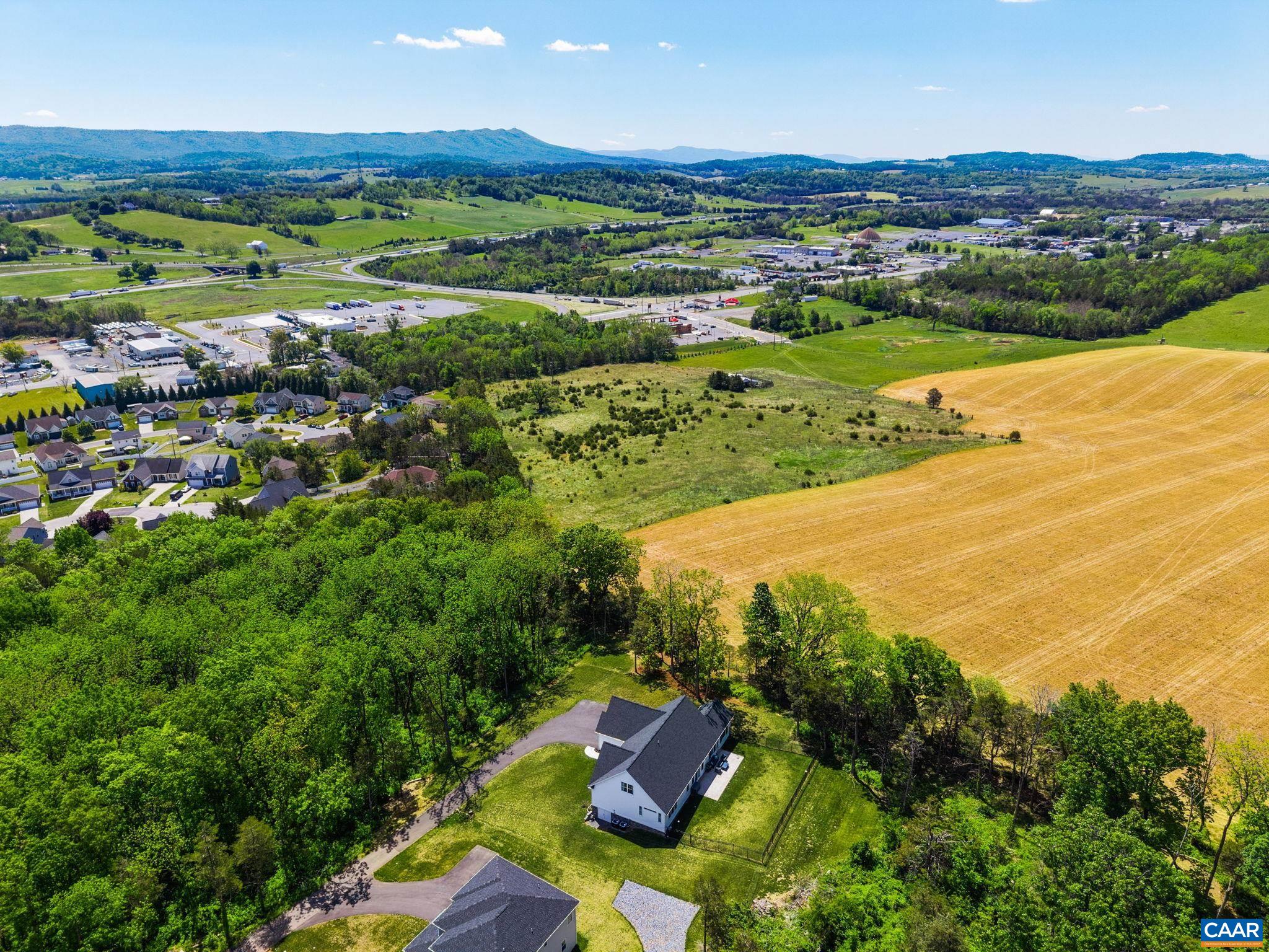 This drone view captures the home looking toward the open field.