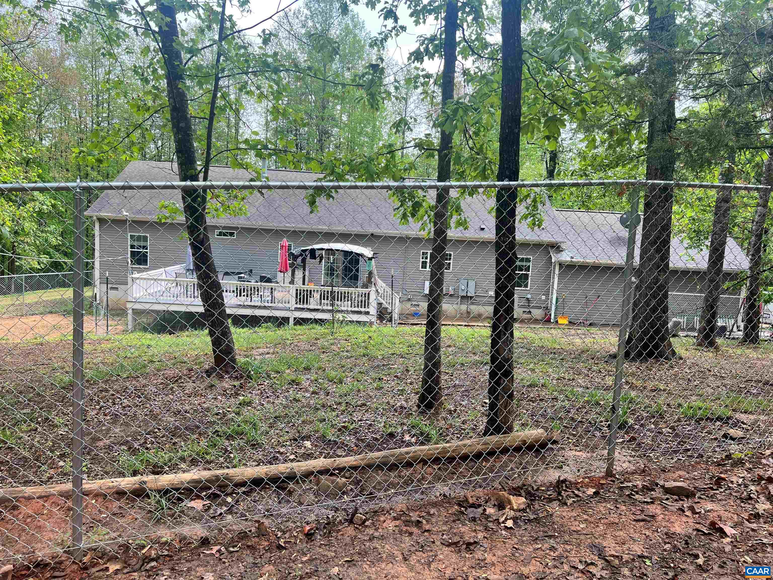 back of house and run in shed and fenced for animals horses chickens goats  whats your pleasure  one floor living and oversized garage.  5 acres separate but part of 10 acres you could use for hunting.  Orange & albemarle county.  Unique home priced sell