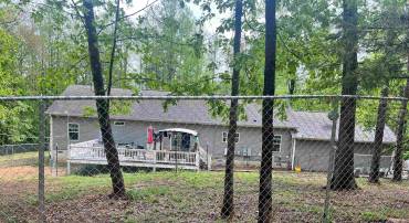 back of house and run in shed and fenced for animals horses chickens goats  whats your pleasure  one floor living and oversized garage.  5 acres separate but part of 10 acres you could use for hunting.  Orange & albemarle county.  Unique home priced sell