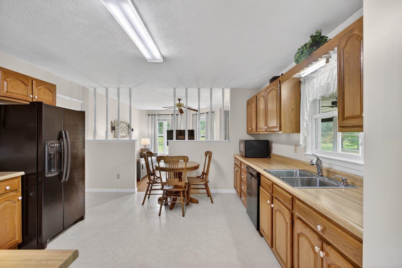Features; vinyl floors, oak cabinets, Formica countertops and appliances.