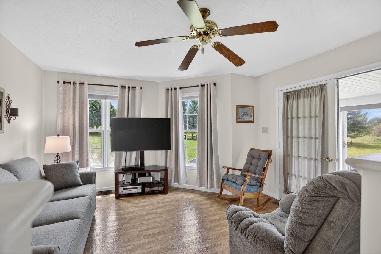 Den is located off the kitchen and opens to the sunroom.