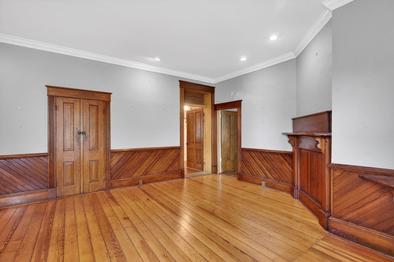This room used to be home to the front of the house and front door. Note the entry door from the foyer. That was the front door to the home in the past. The other door to the right connects to the music room.