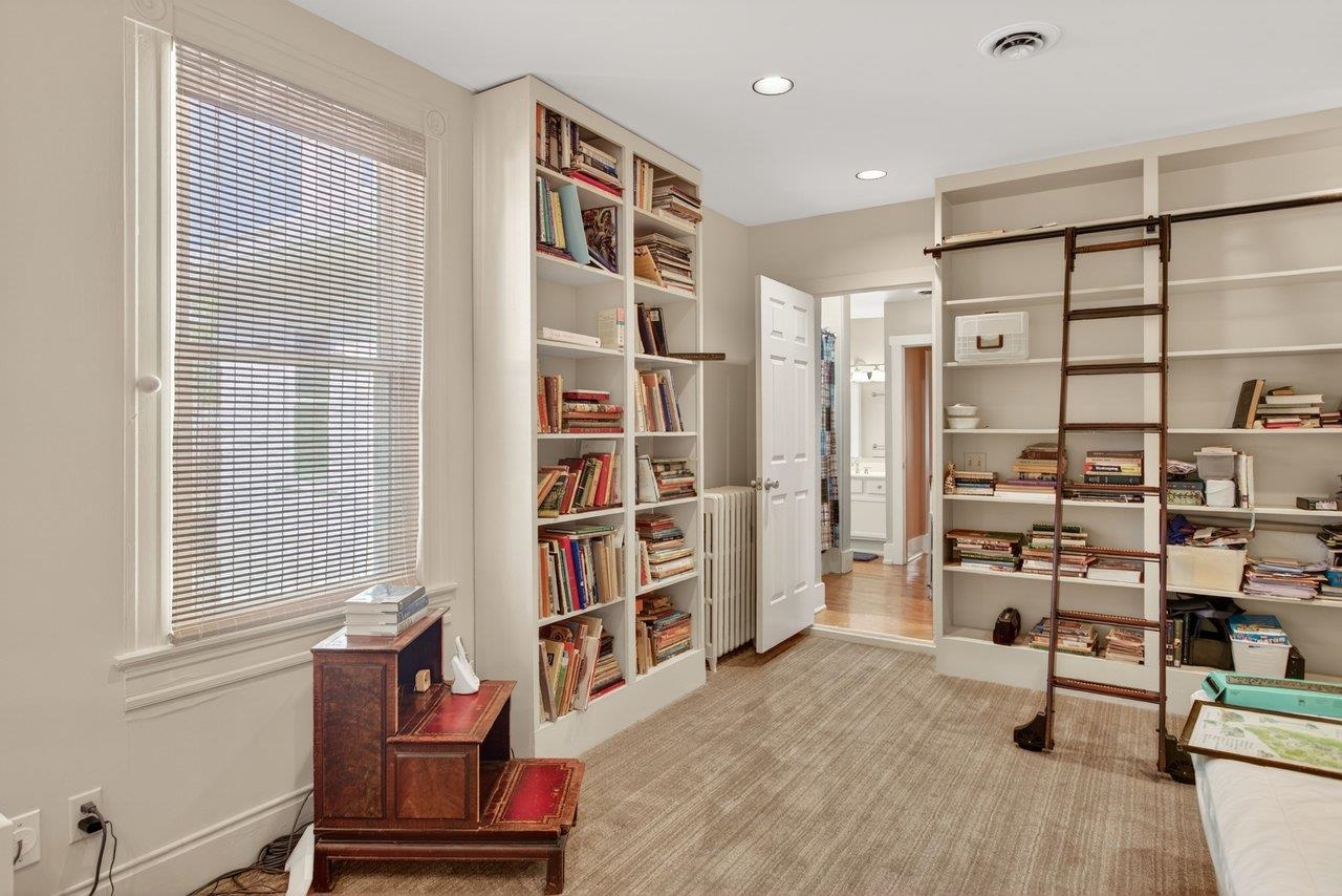 This is a bedroom which resides off the back of the home on the second level. This room connects to the back staircase, has a laundry room, built in shelves and is attached to the bathroom 2.