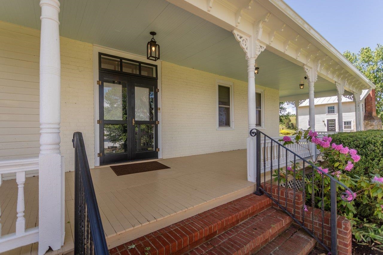 Lovely double door entry, large porch perfect for sitting and relaxing.