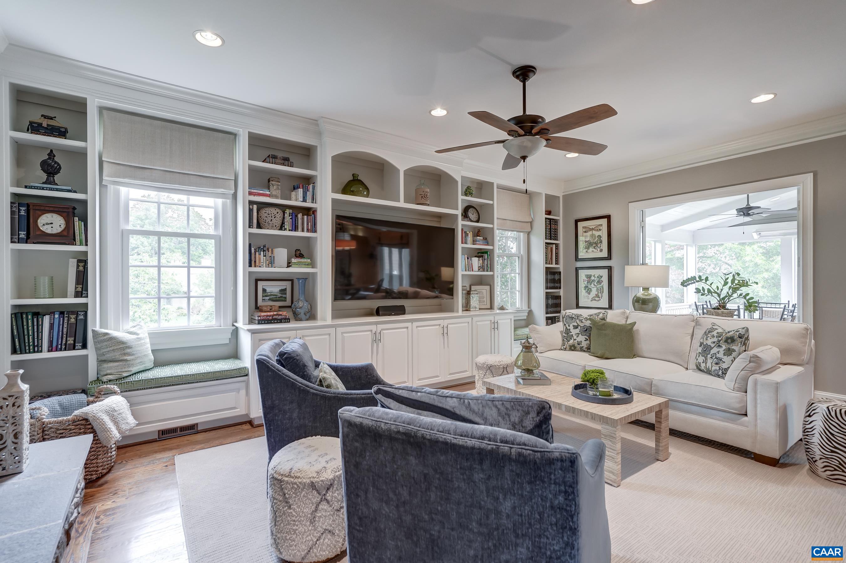 Great room boasts more built-in storage and a beautiful stacked stone fireplace.