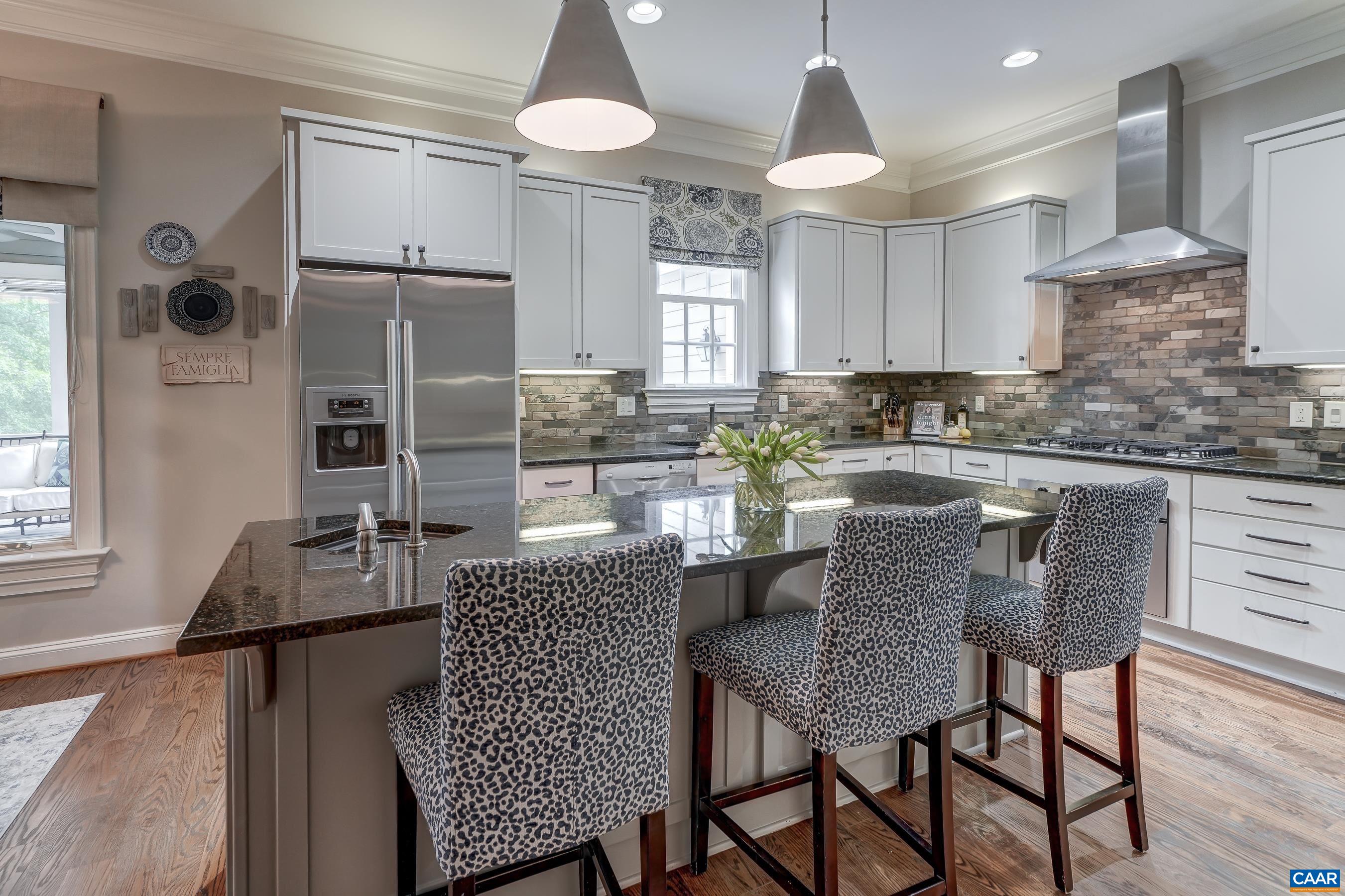 Completely renovated kitchen features custom cabinets, granite counters and stainless steel appliances.