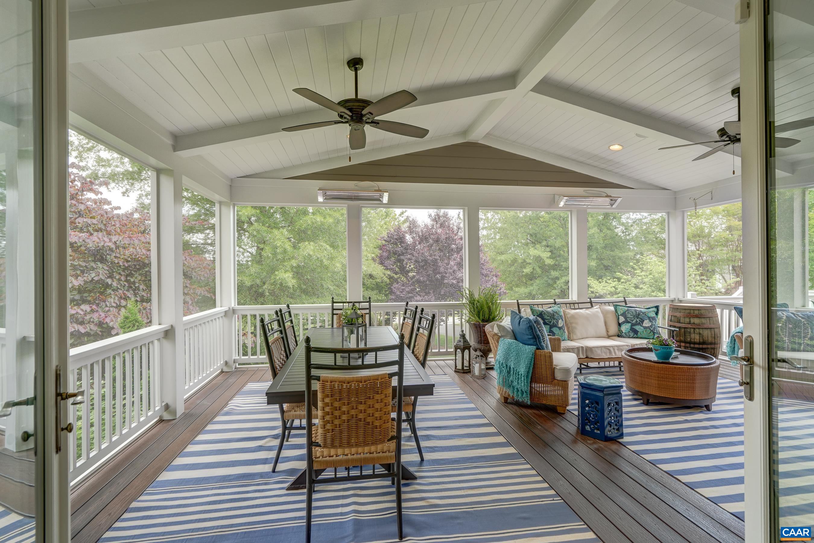 Take the living outdoors on the expansive screened in porch with ceiling fan, speakers, and infrared heaters!