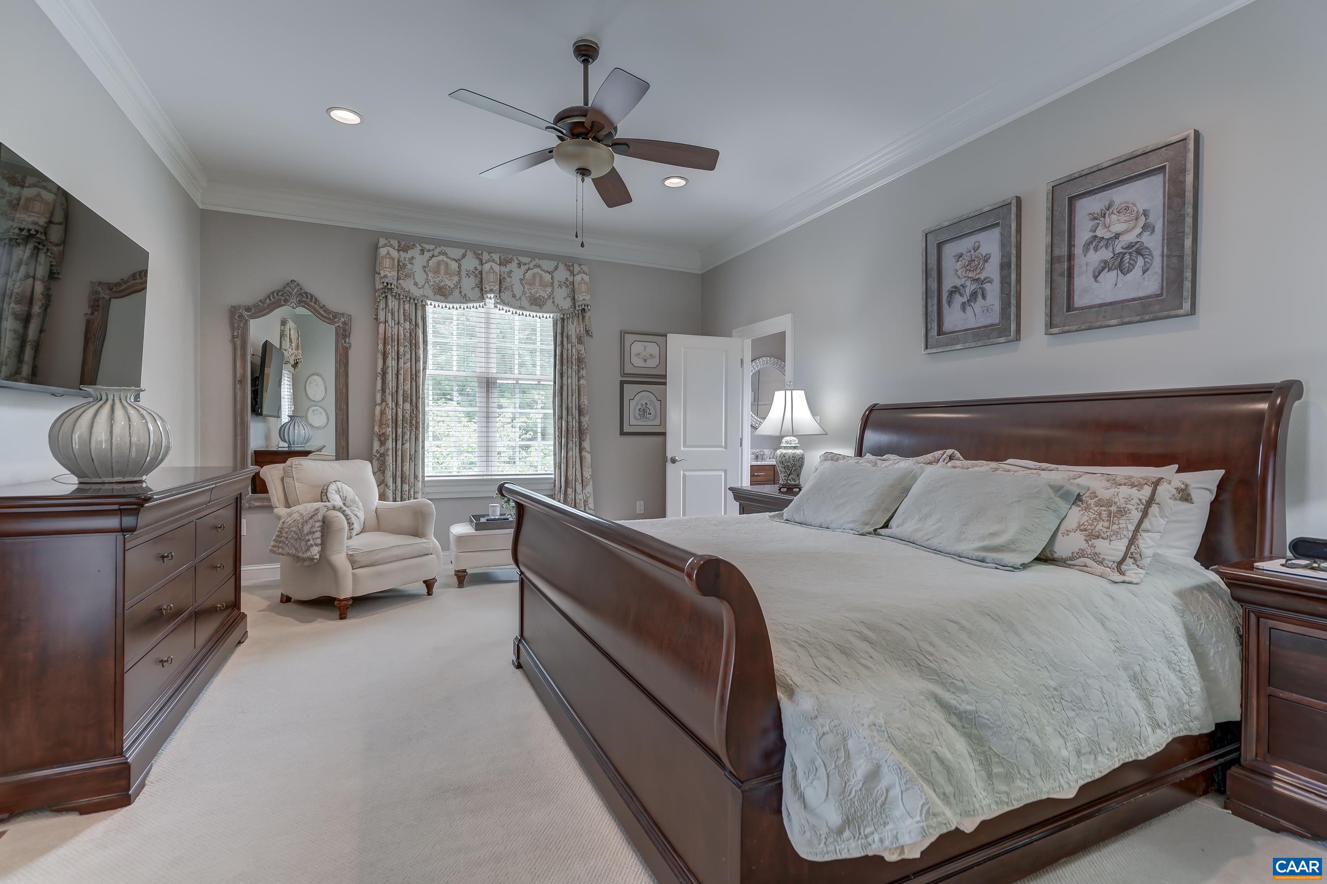 Main level primary suite is a private escape from the bustle of the home.