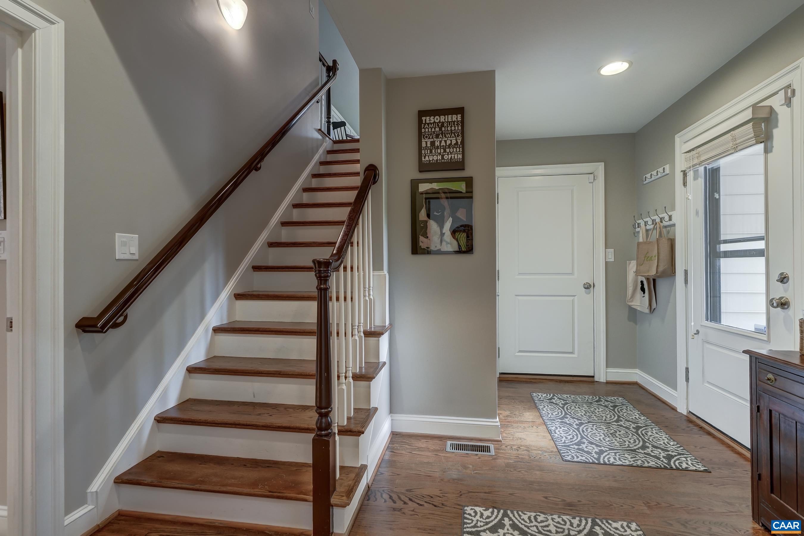 Mudroom entry way with second set of stairs.