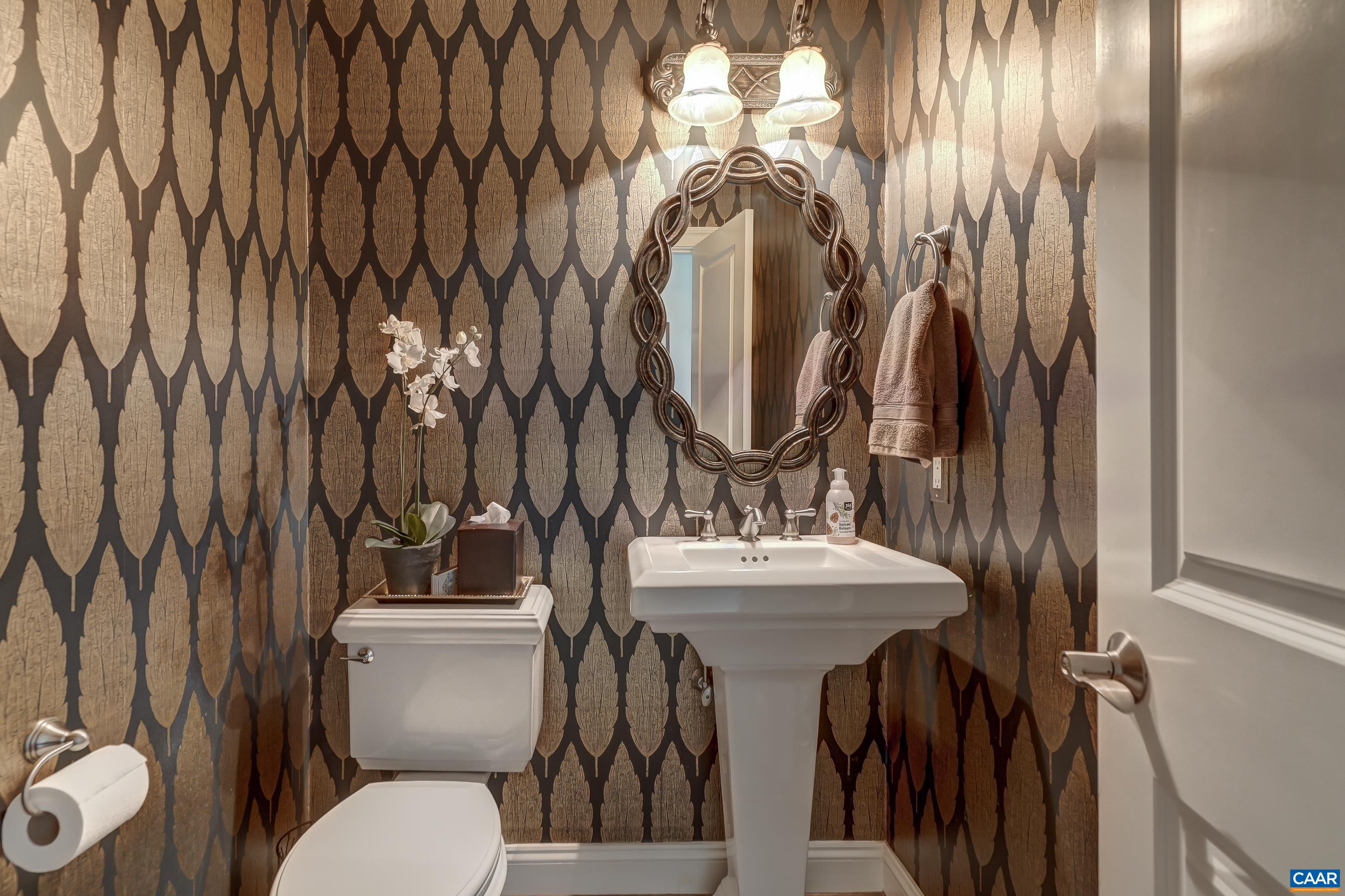Powder room with custom wall covering.