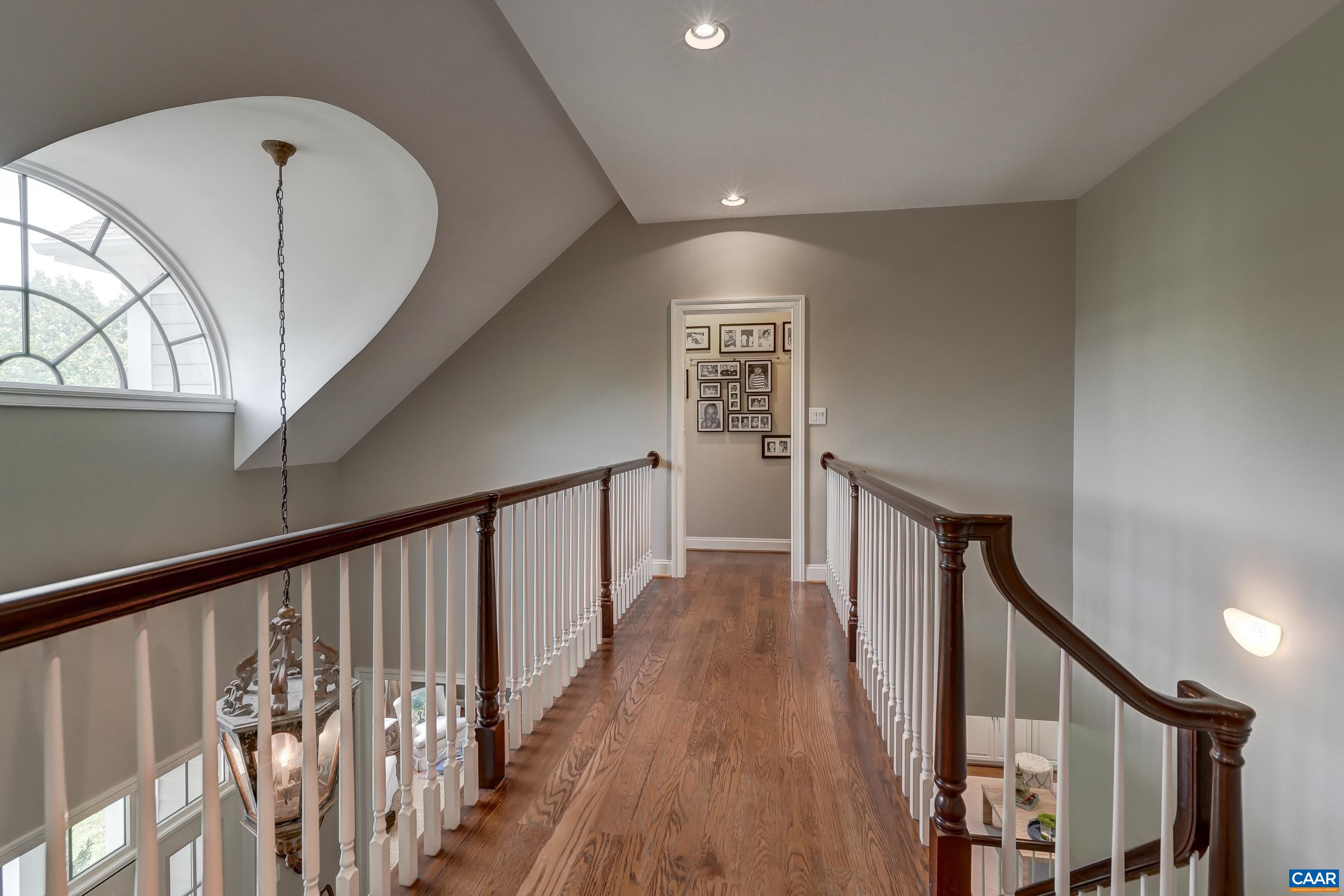 Second floor features an open hallway with hardwood floors