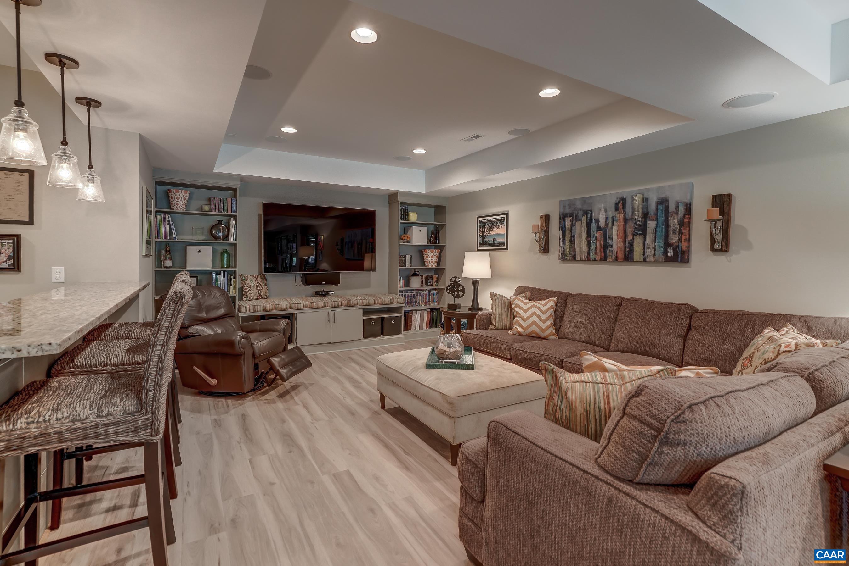Rec room with built-ins in basement.