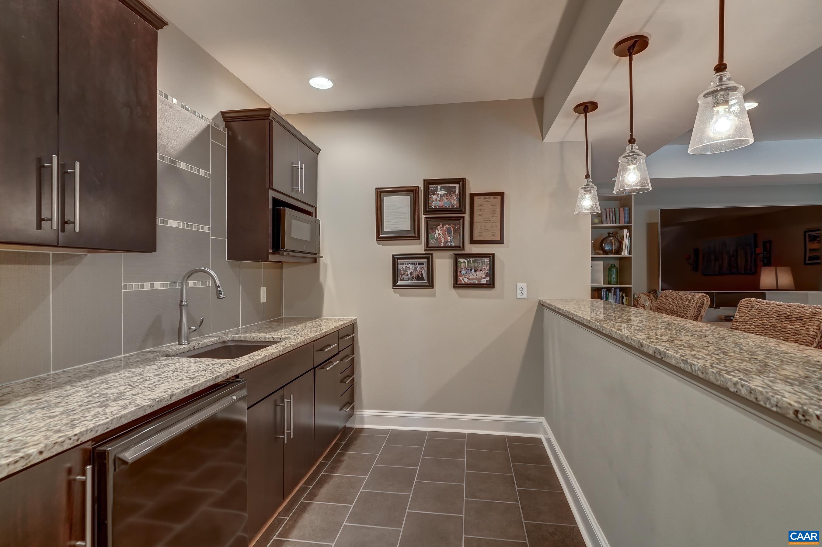 Bar with beverage fridge and microwave.