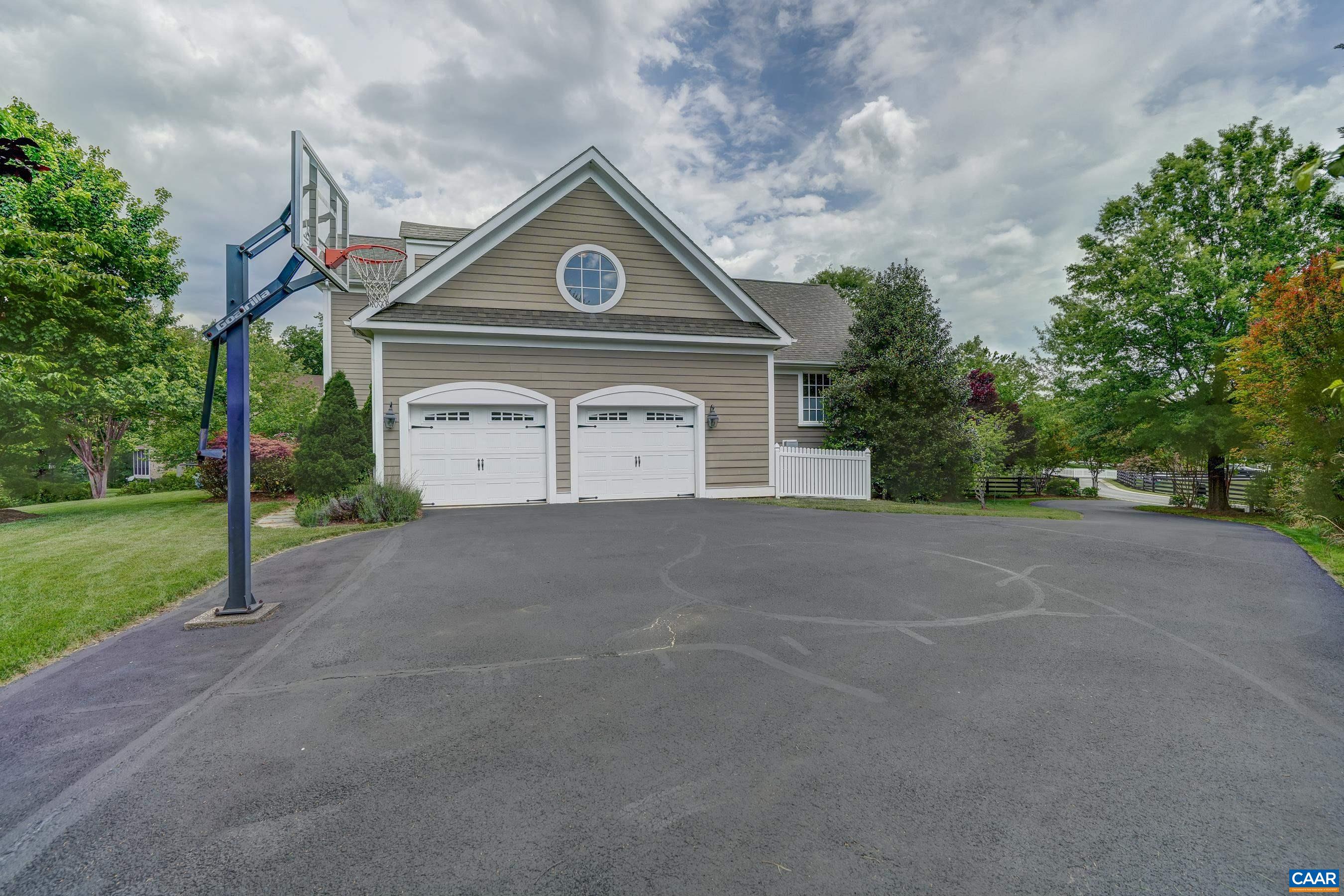 Side entry garage features EV charger, and newly sealed driveway features in-ground basketball hoop.
