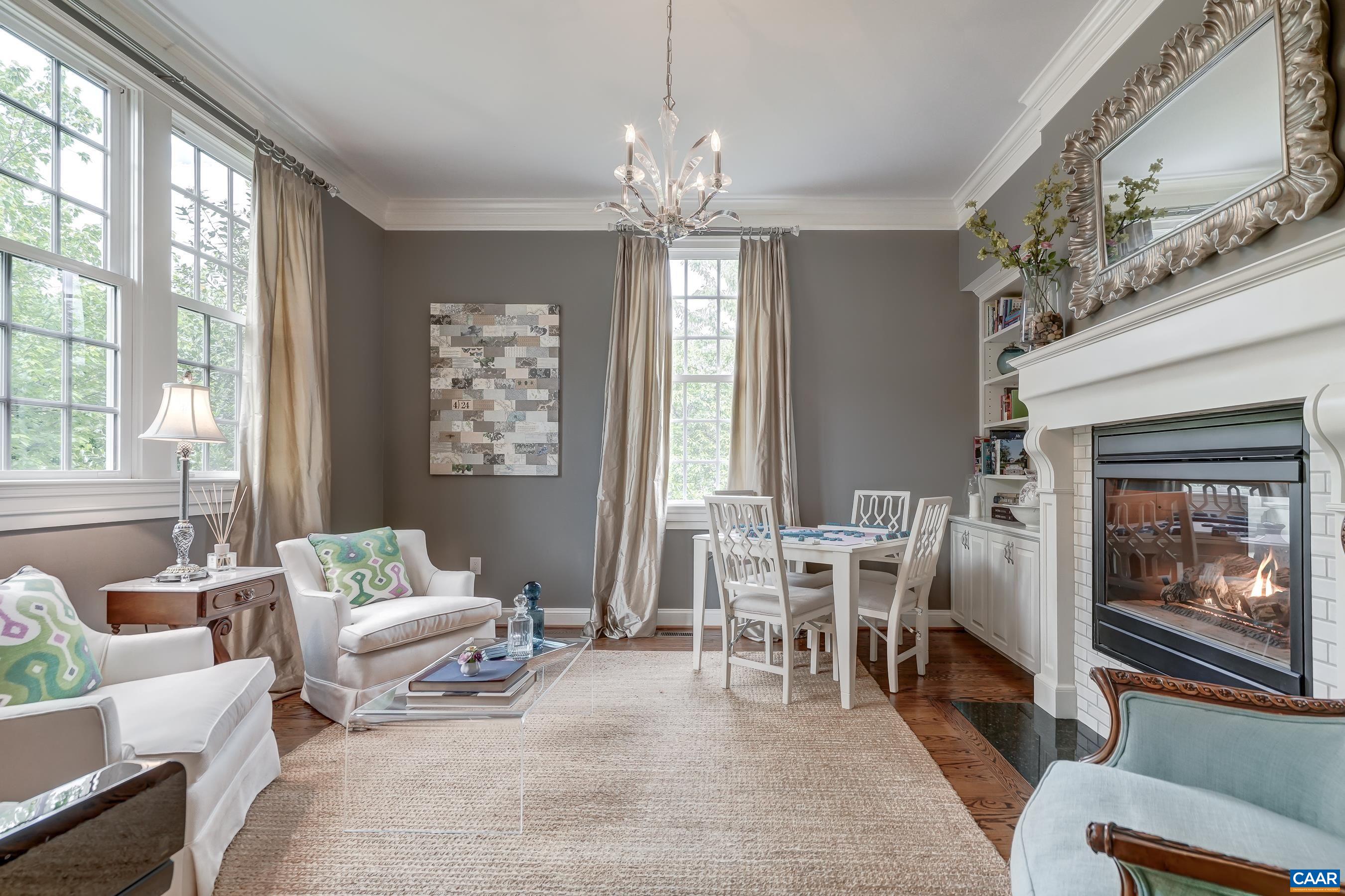 Formal living room features a dual sided gas fireplace with built-ins on both sides.