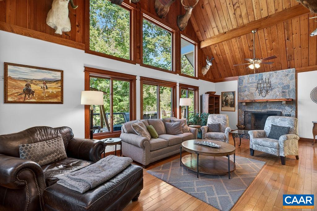 Beautiful great room with soaring cathedral ceilings and a stunning stone wood-burning fireplace.