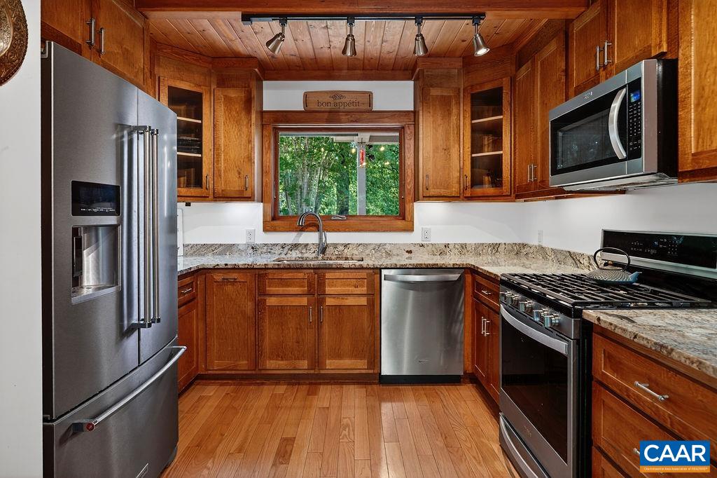Chef's kitchen complete with stainless steel appliances, custom maple cabinets and granite countertops.