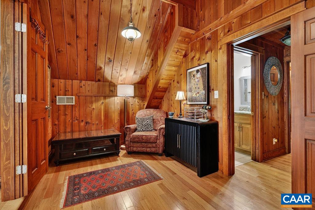Cozy bonus room adjoining the upstairs guest suite, ideal for a hobby room, office, exercise space, or peaceful meditation and reading retreat.