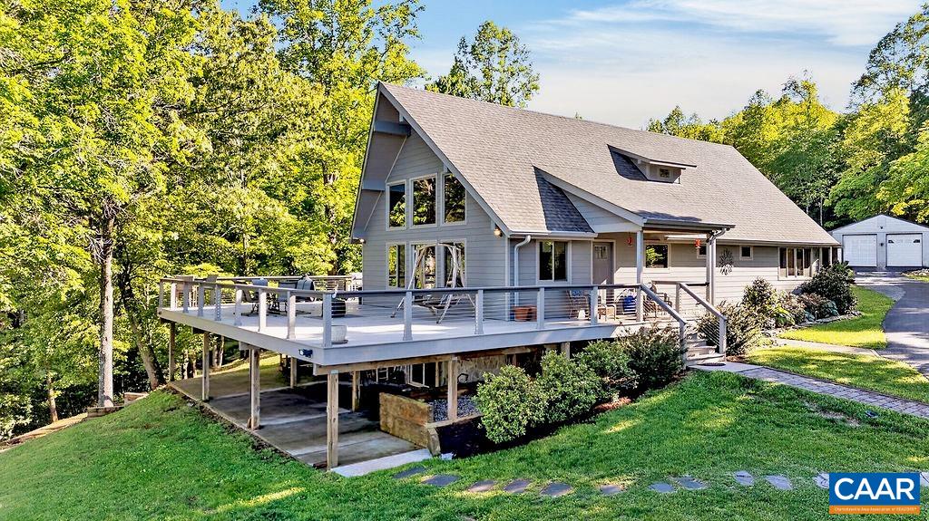 Stunning home featuring 3 bedrooms, 3 full baths, a spacious family room, and an expansive Trex deck with stainless steel railings that wraps around three sides of the home.