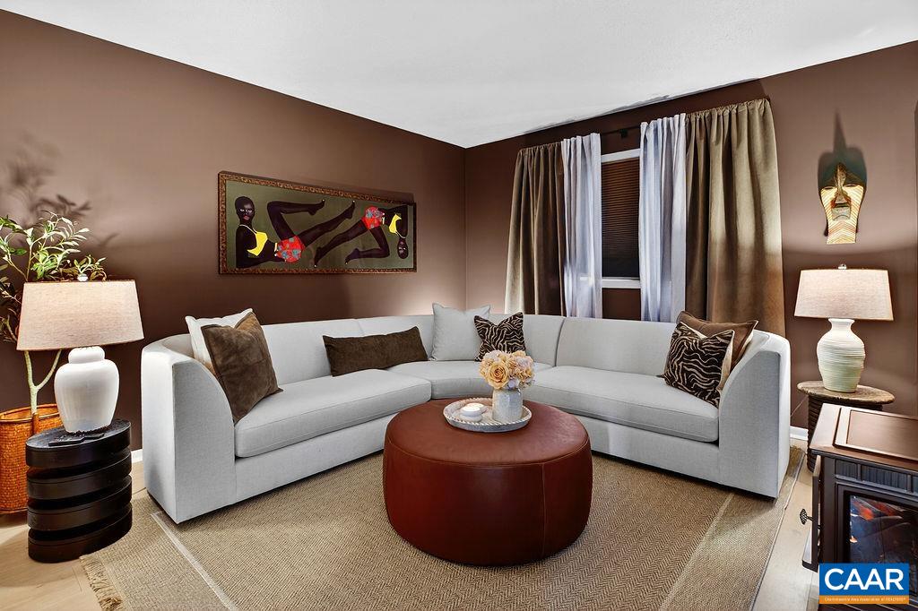 The main-level bedroom has been transformed into a cozy yet luxurious family room and home theater space.