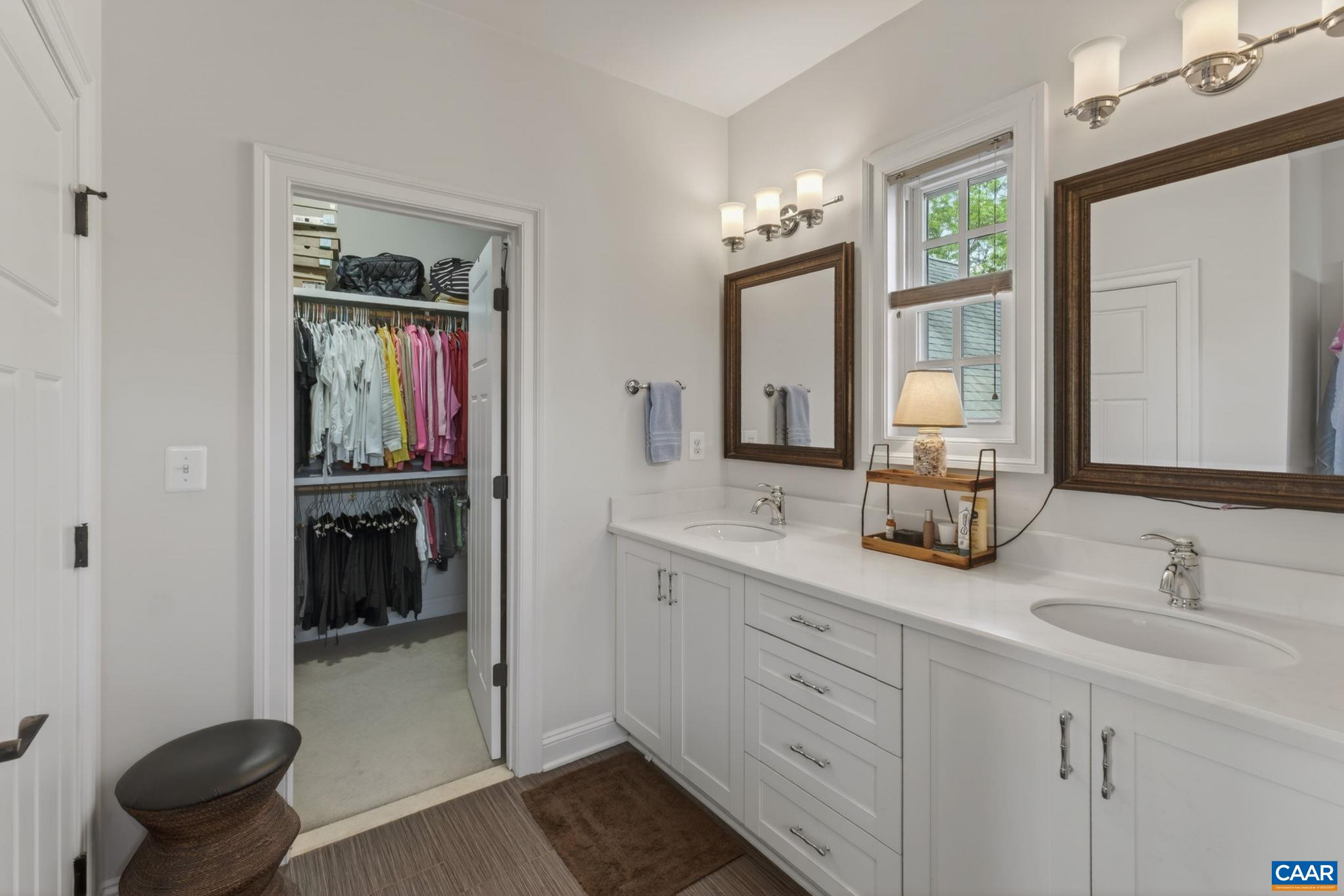 Primary bath with large walk in closet, dual sink vanity.