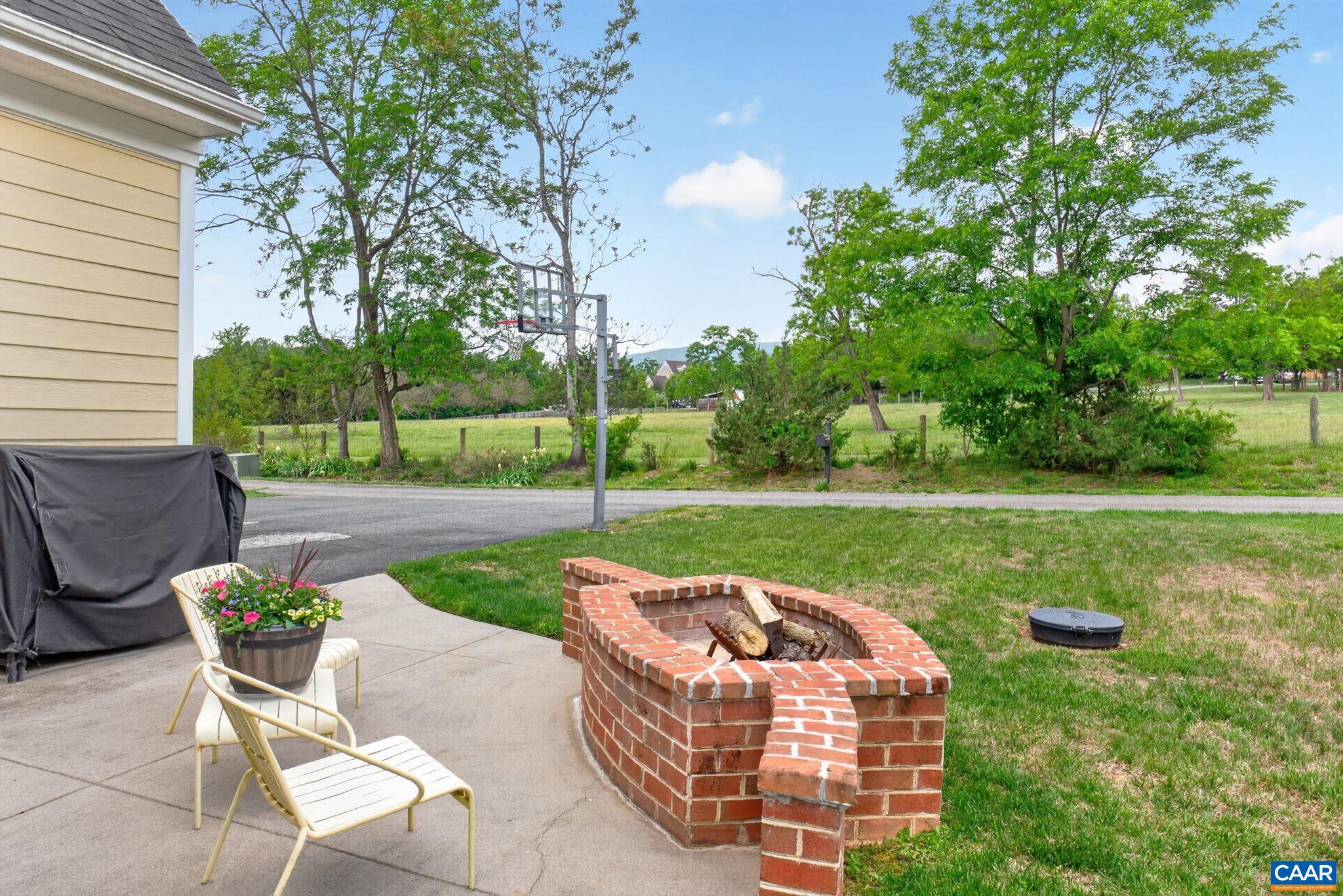 Gas-start wood burning firepit on rear patio.