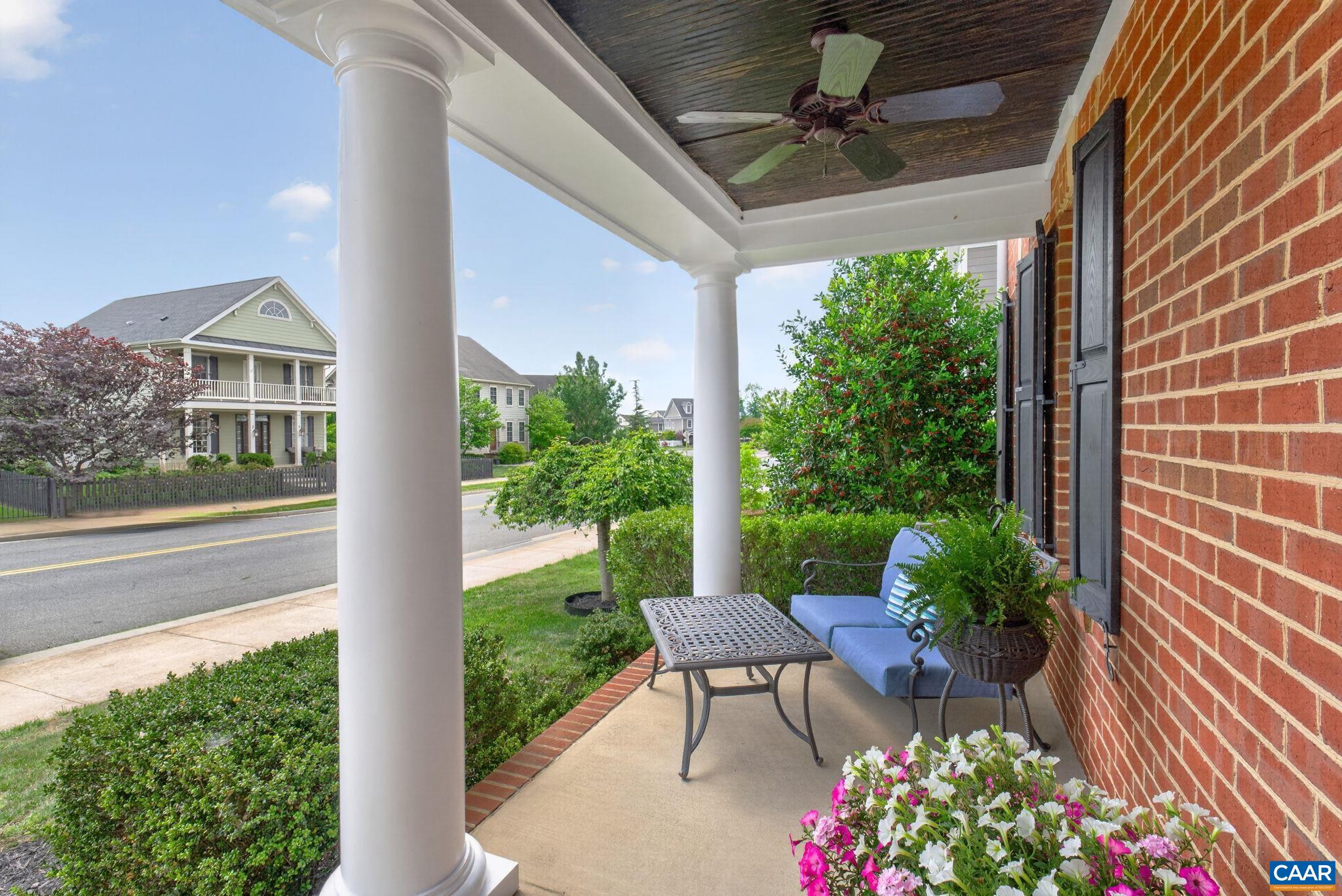 Welcoming 8' deep front porch with ceiling fans.