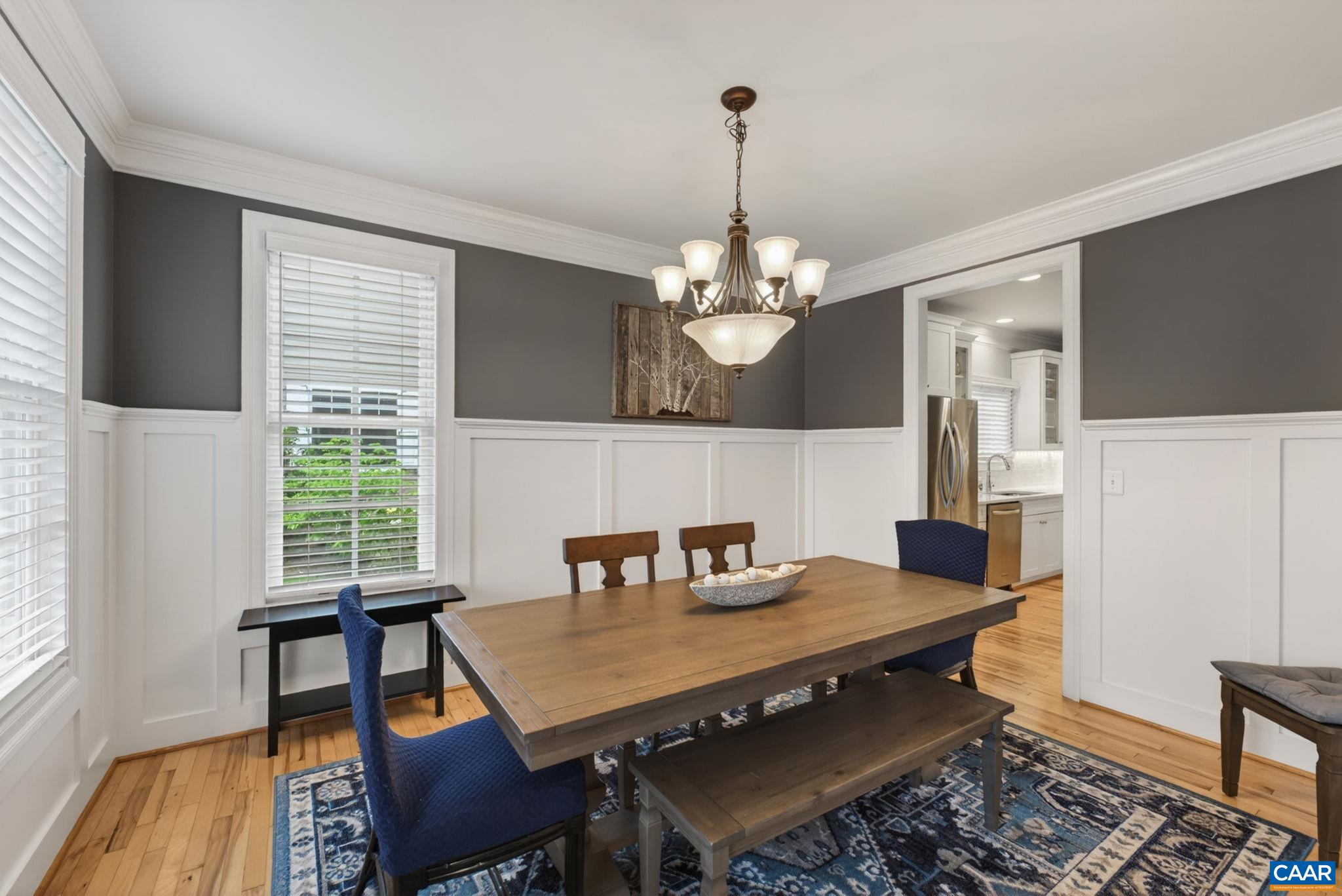 Dining room off front foyer with custom wainscoting and door to the kitchen. All windows low E with argon gas insulation.