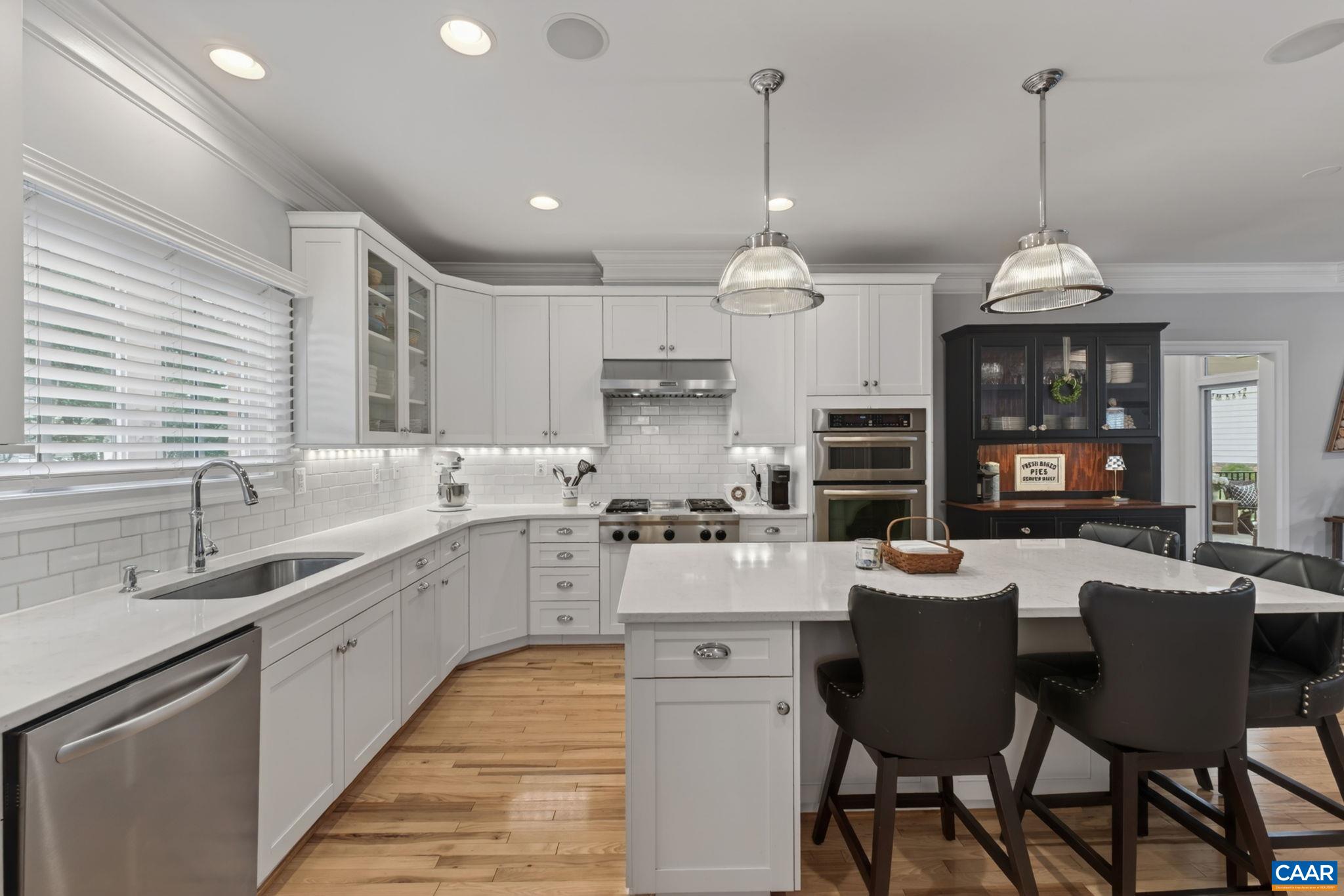 Large bright kitchen with center eating island.