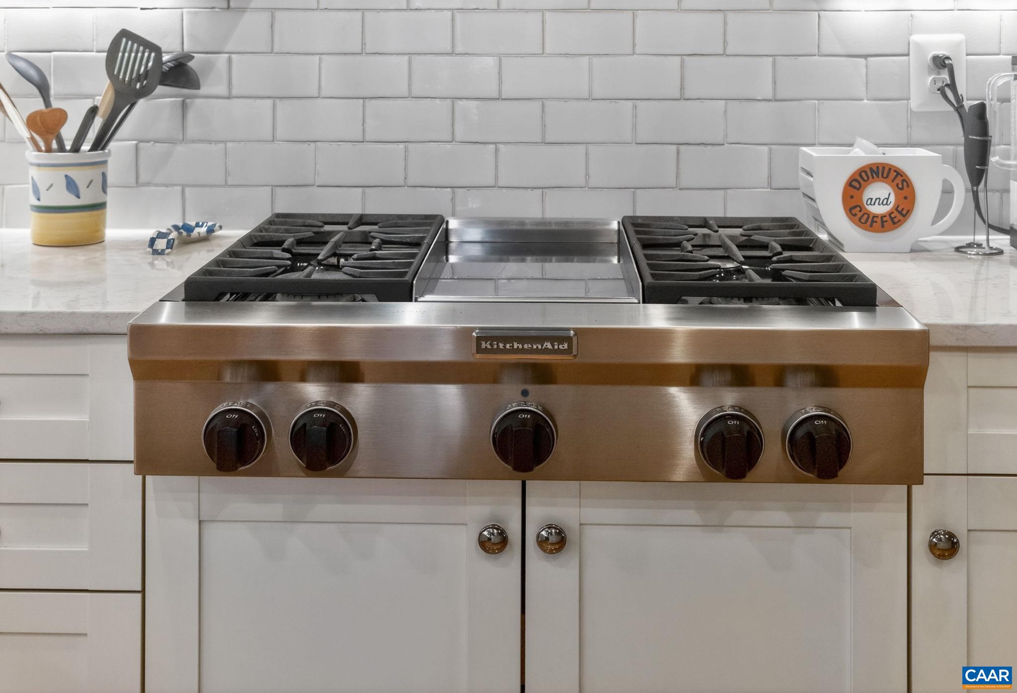 Commercial KitchenAid gas range and vent.