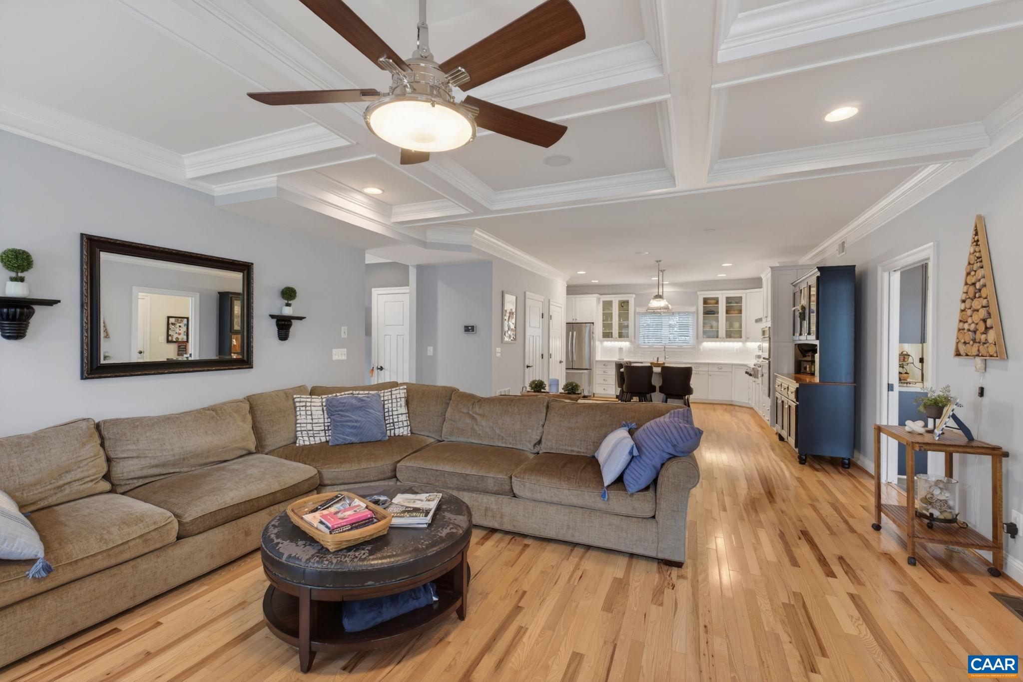 Family room with ceiling fan, coffered ceiling.