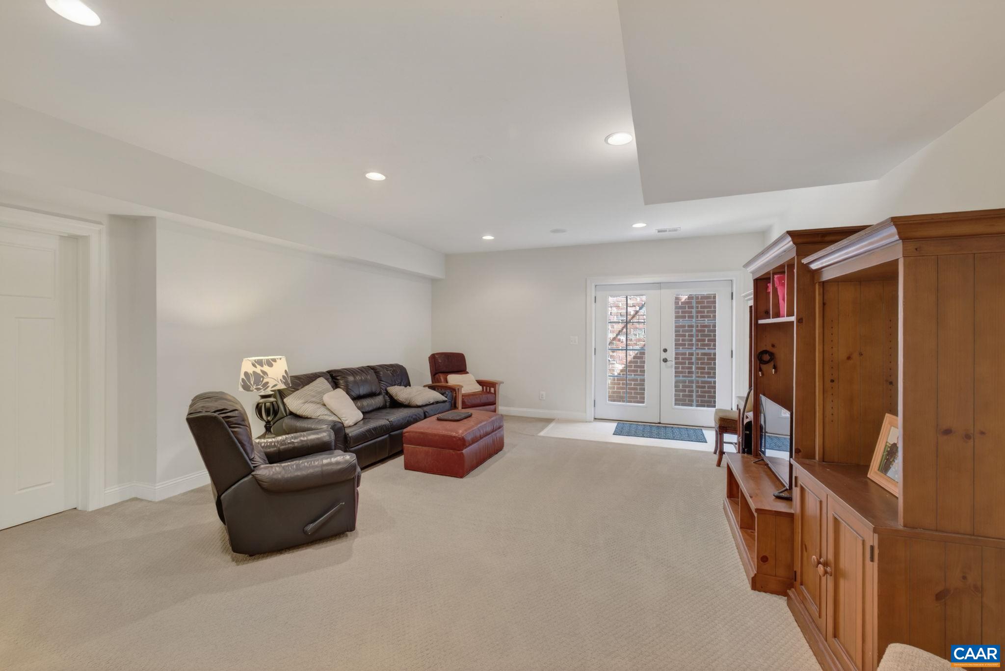 Large lower level family/rec room with large finished storage closet and outdoor access.