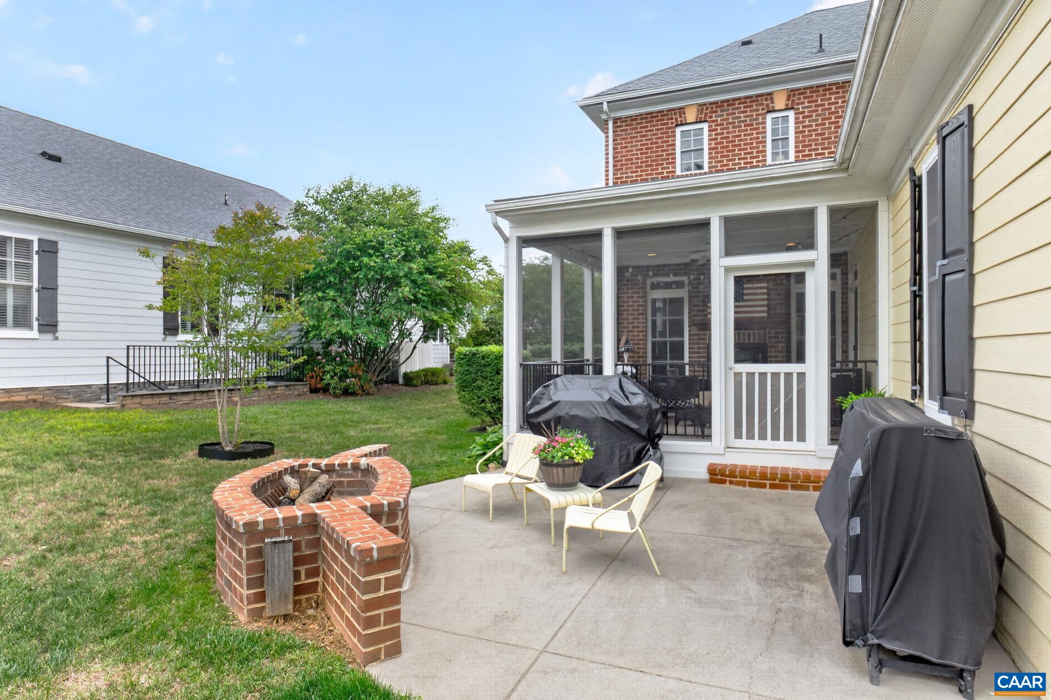 Rear patio with firepit and screen proch.