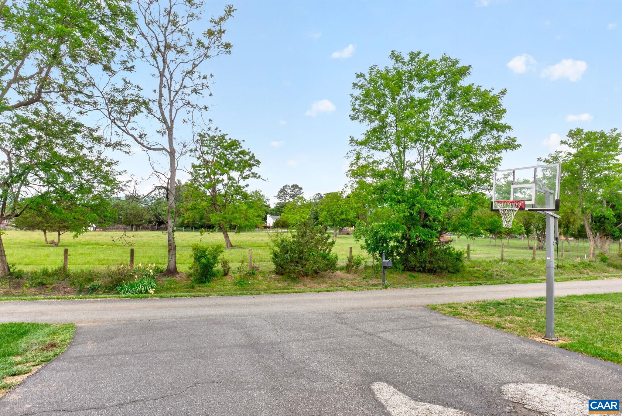 Back driveway has plenty of parking space and hoop for a pickup b-ball game.