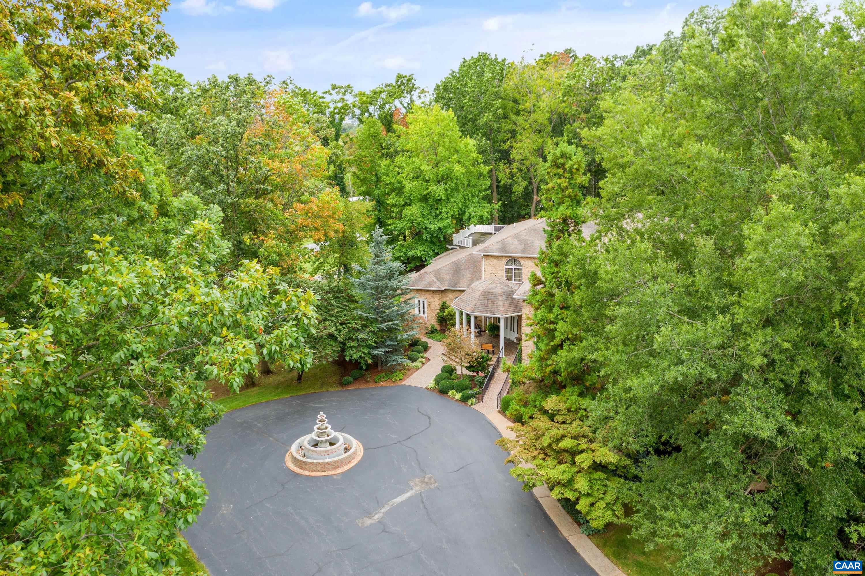 Circular driveway to main entrance and covered front porch in view.