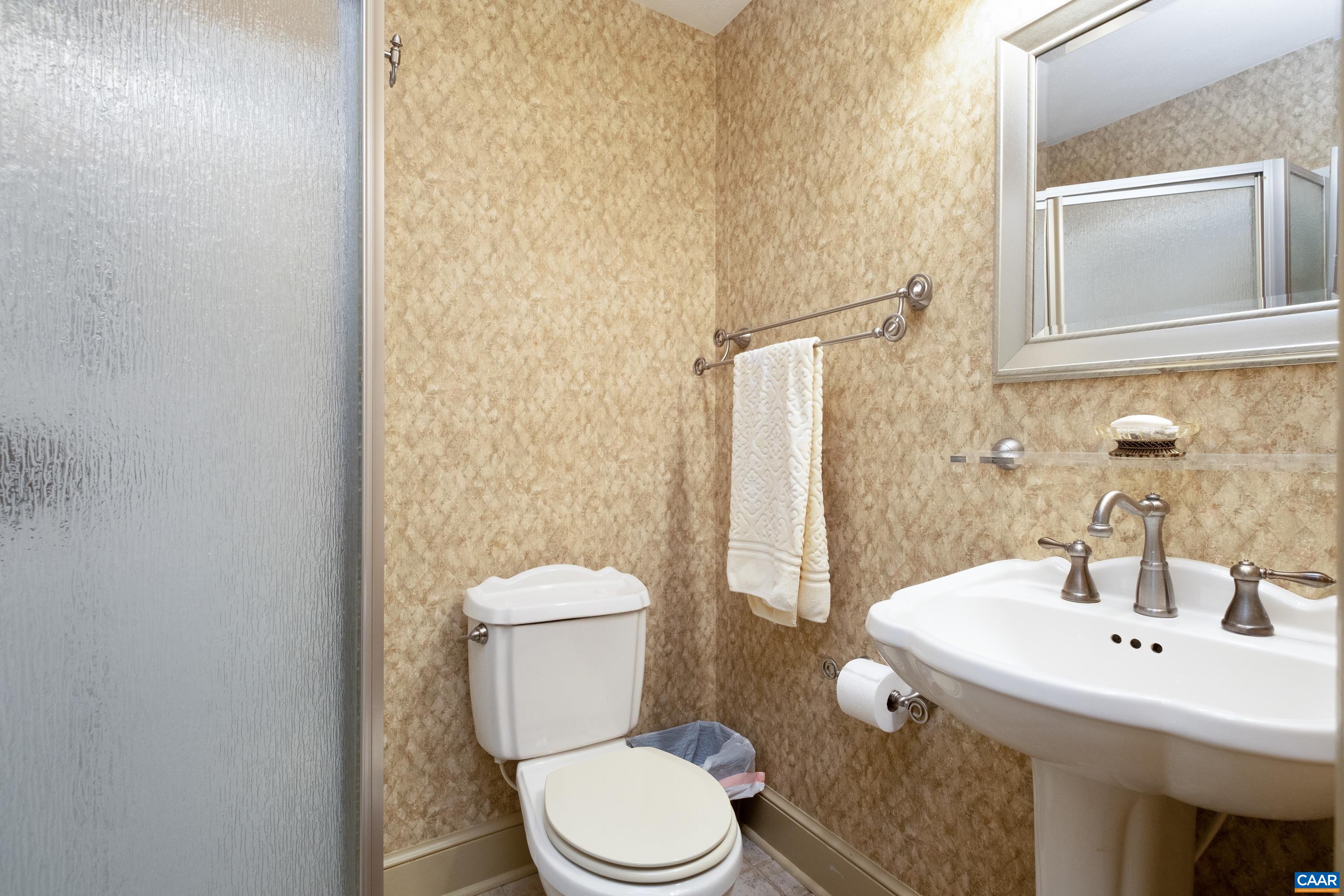 Ensuite bathroom #3 features a shower stall and pedestal sink.