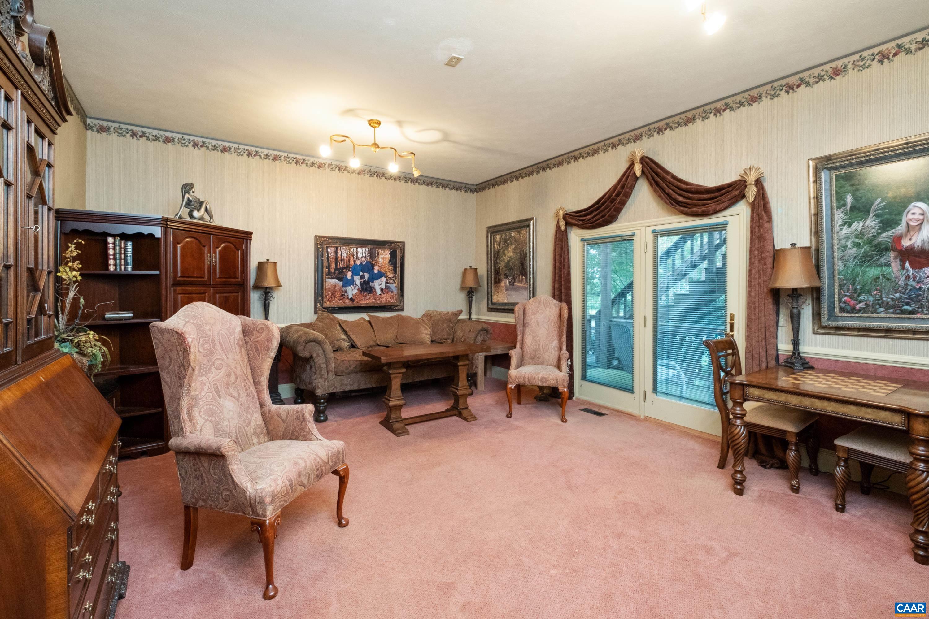 The main level includes a great room, several rooms off of the great room, a production wing, and an office wing,  This study is located just off of the great room, and features a closet and a private deck.