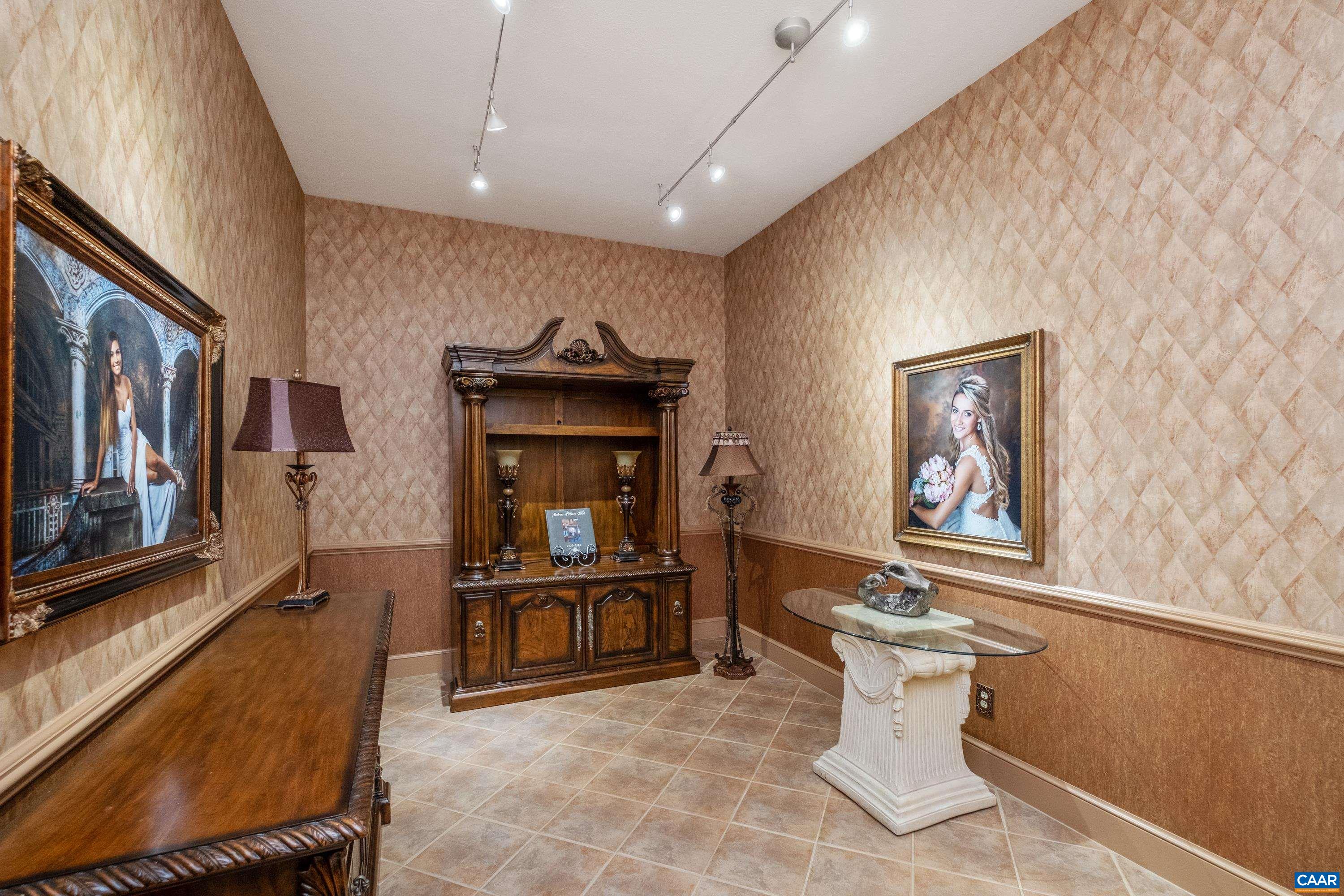 This is a multipurpose/combination room that is currently being used as a sitting room, and is located beside the study.