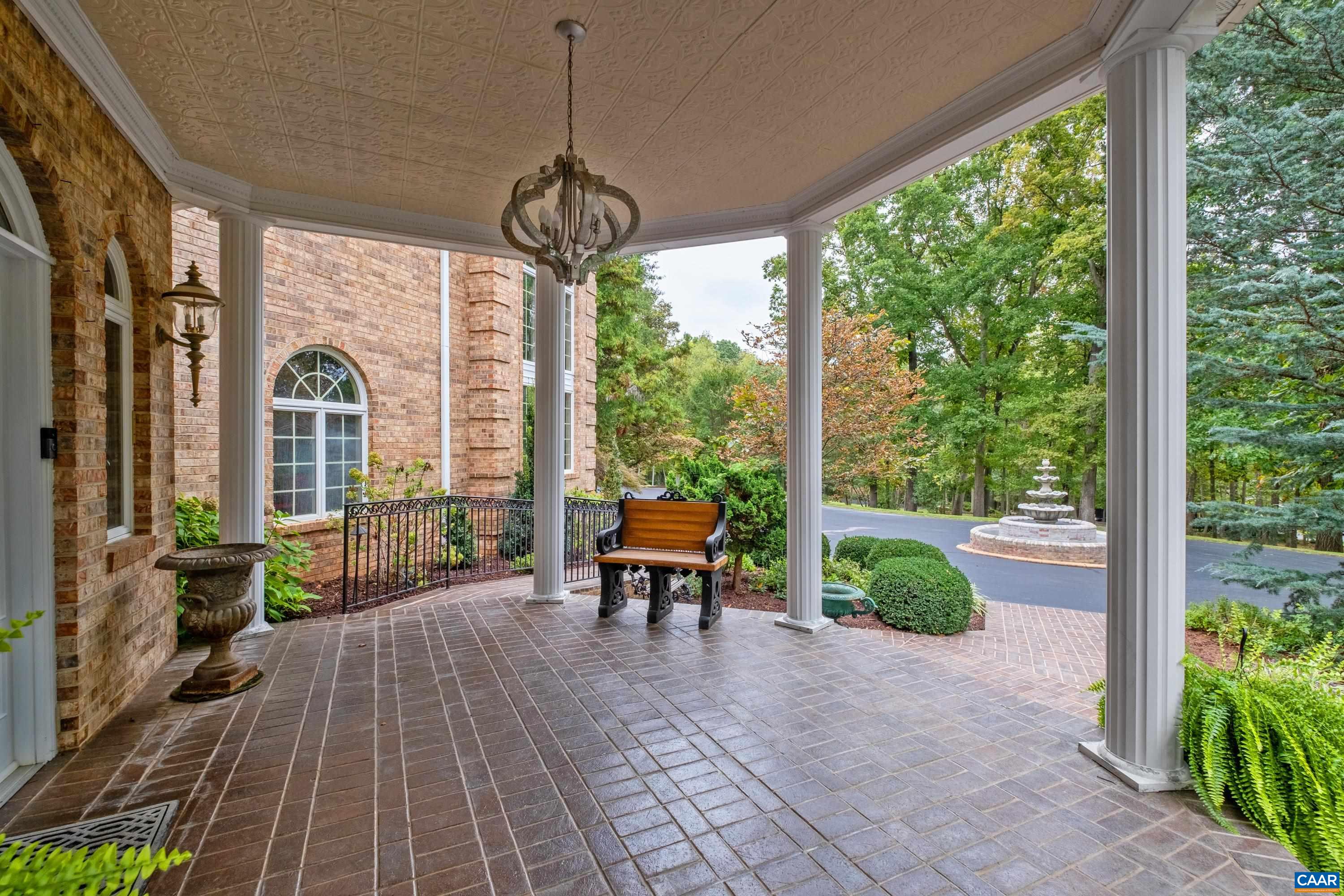 Property features a covered brick front porch, with multiple pillars.