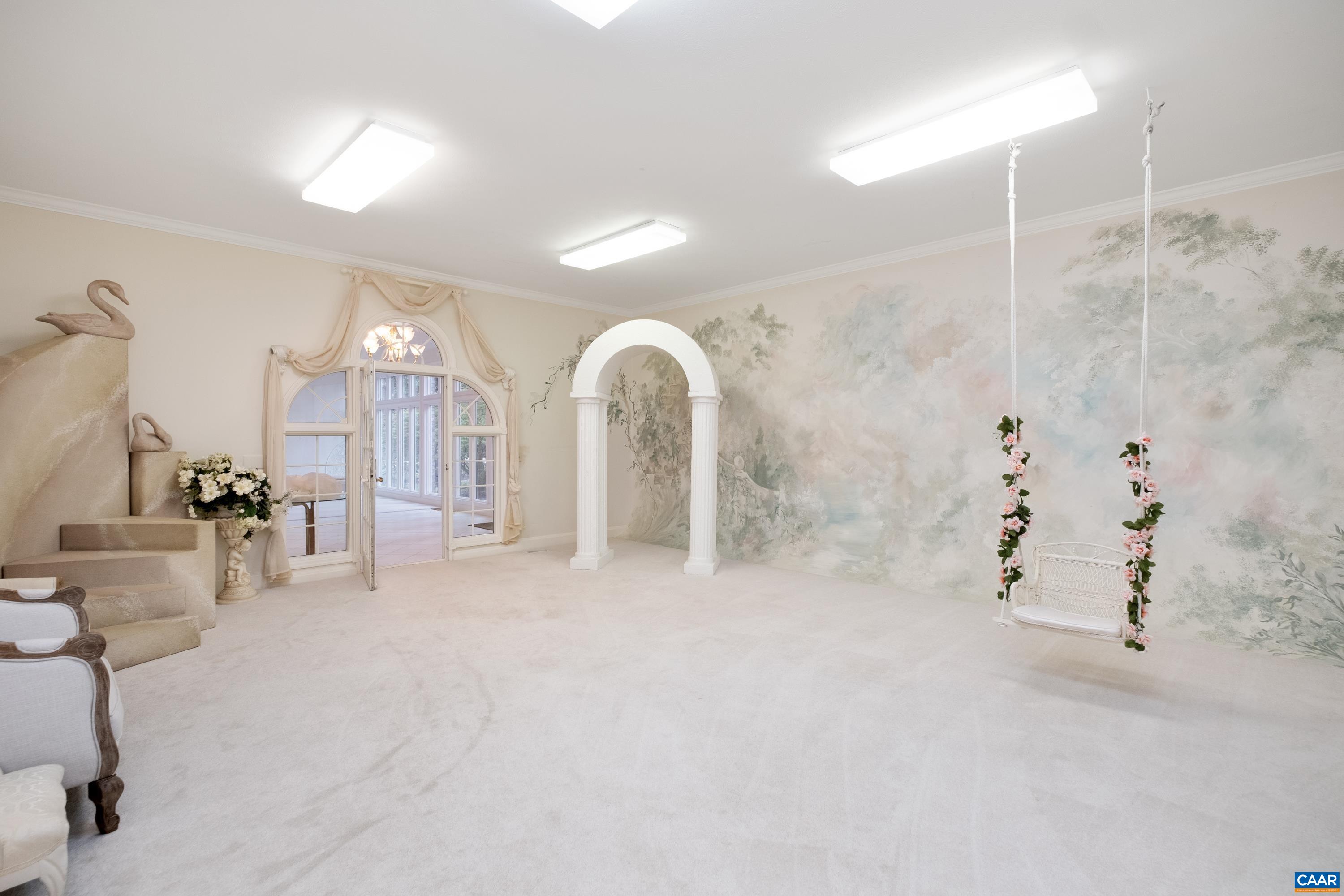 This large room is currently being used as a photography studio, with the sunroom just beyond.  Not pictured is a walk-through closet that connects this studio to an adjacent studio.