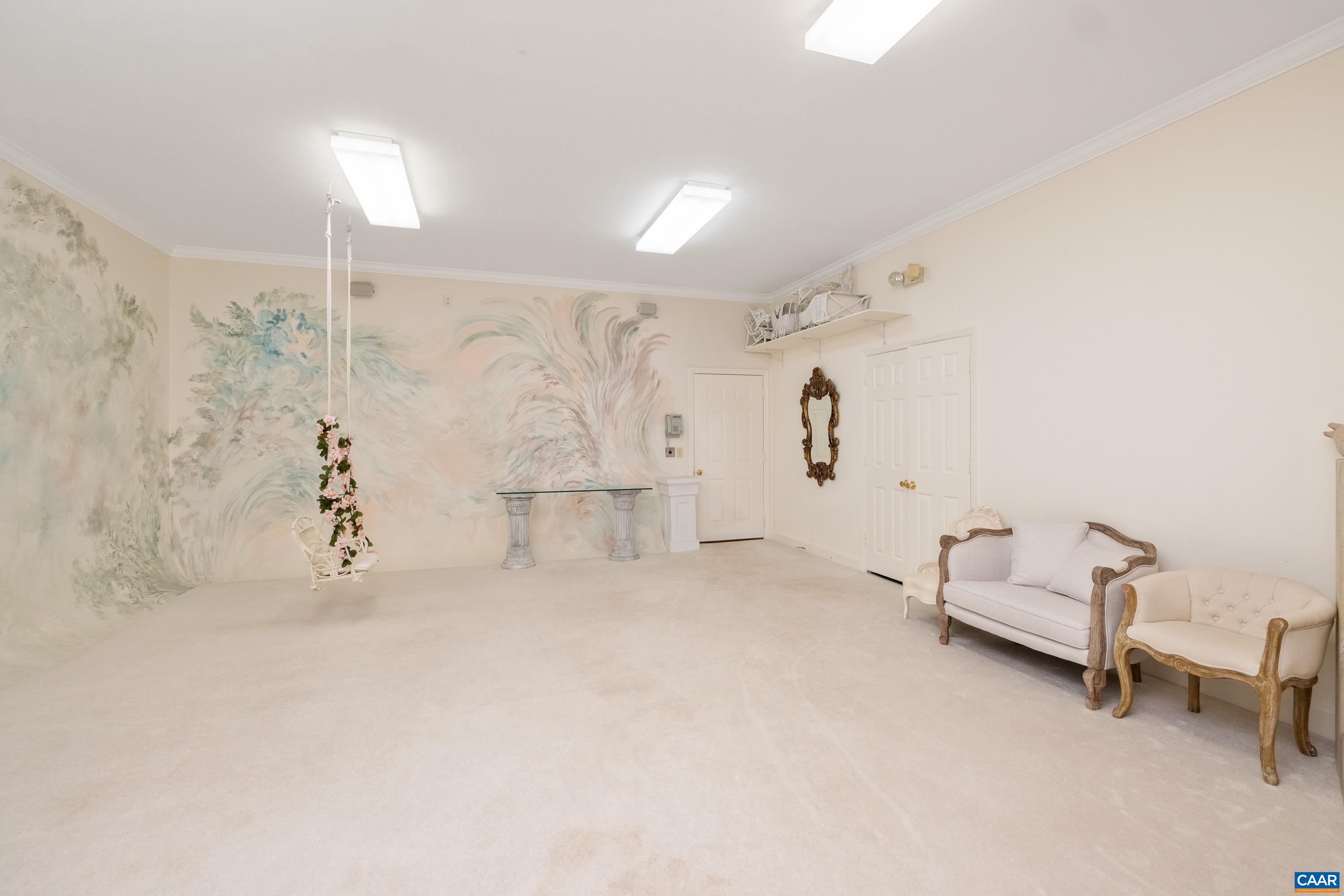 This is an alternate view of the photography studio, with a door to a walk-through closet in view.