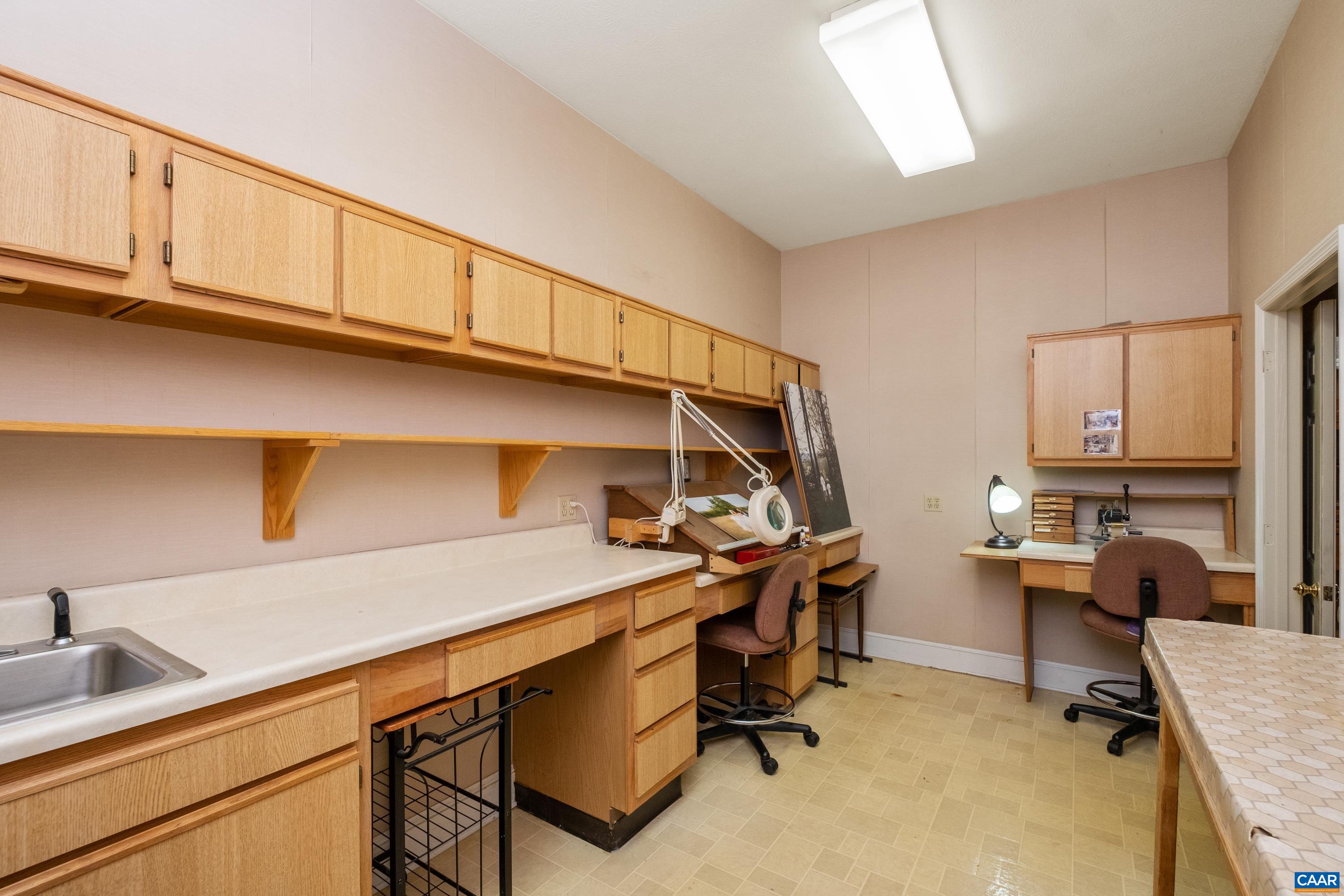 Work room adjoins office/workspace room, and includes a walk-in closet.