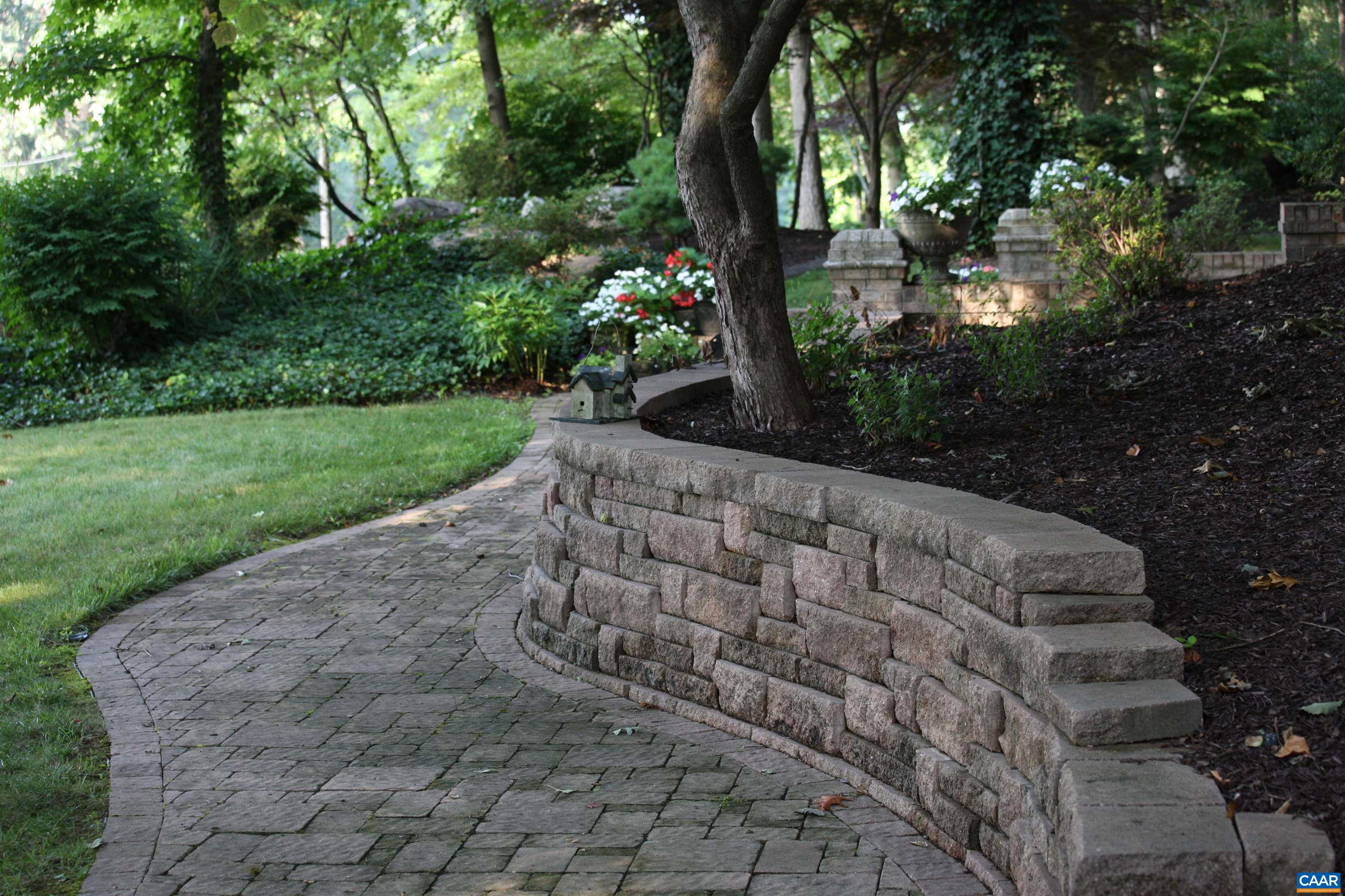 Grounds feature multiple stone paths and retaining walls, along with multiple courtyards.