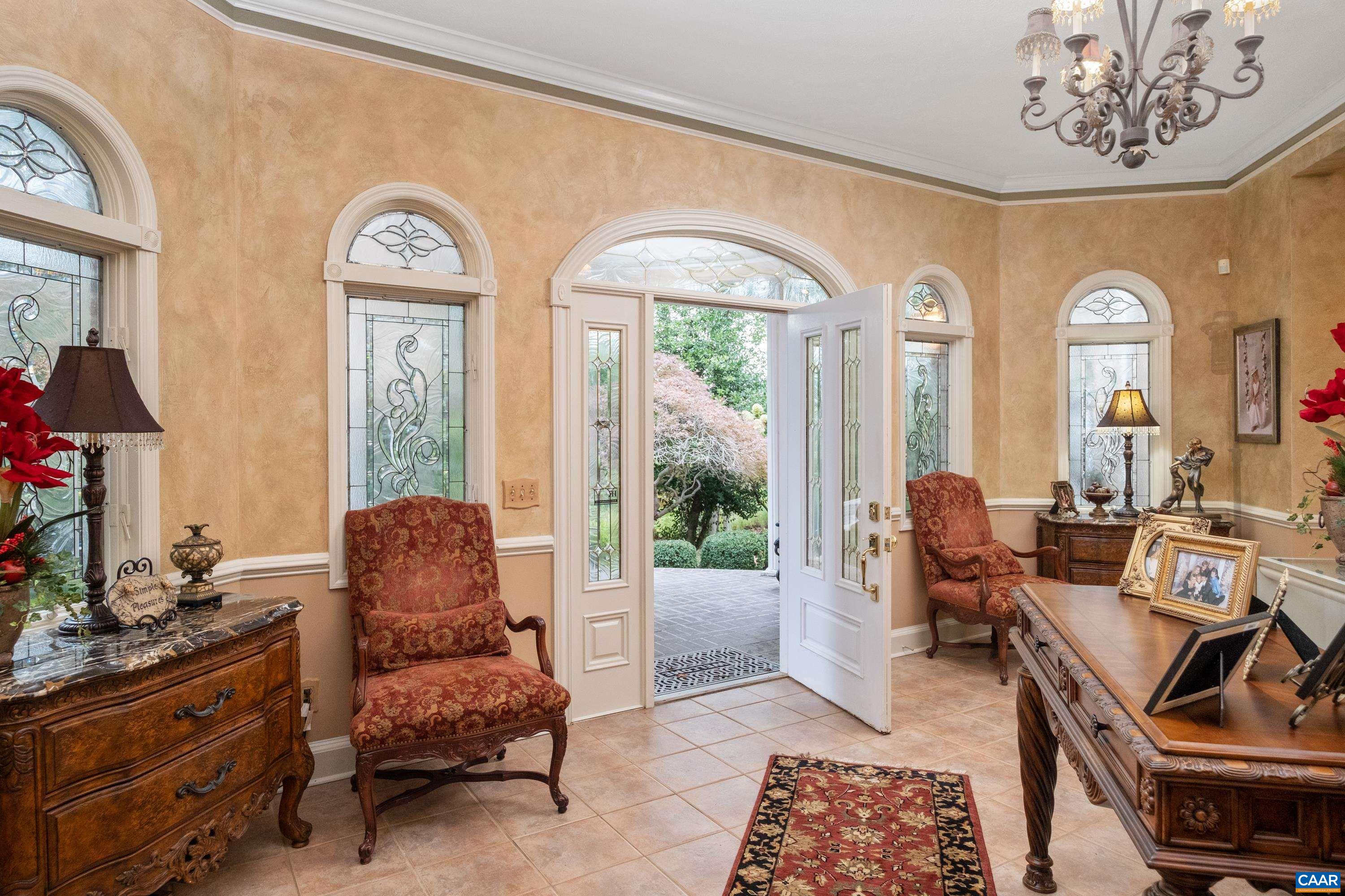 Grand entrance into foyer, then into the great room with balcony and winding staircase.