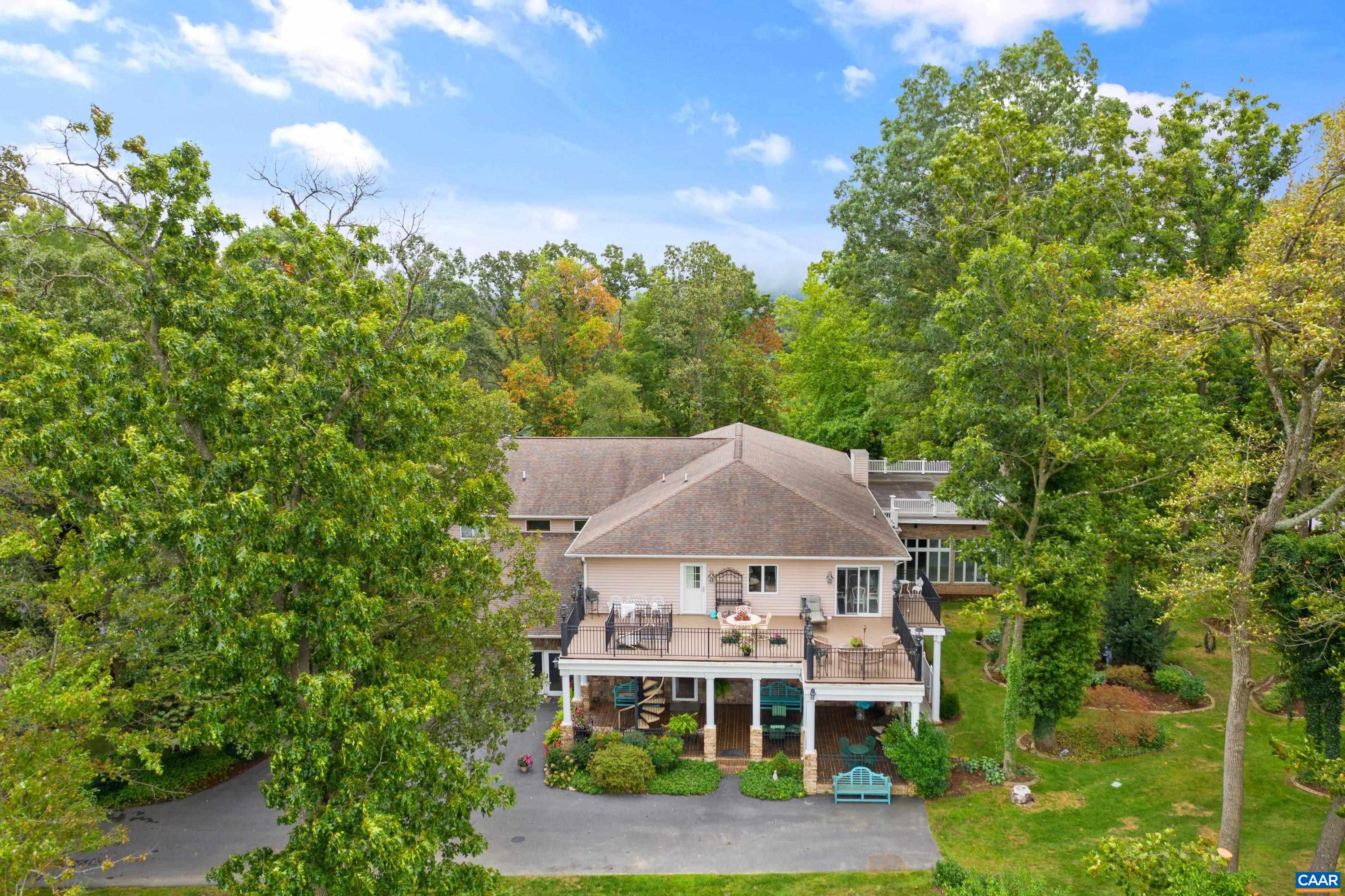 View from drone of the back of the property with mountain views in the distance.