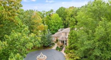 Circular driveway to main entrance and covered front porch in view.