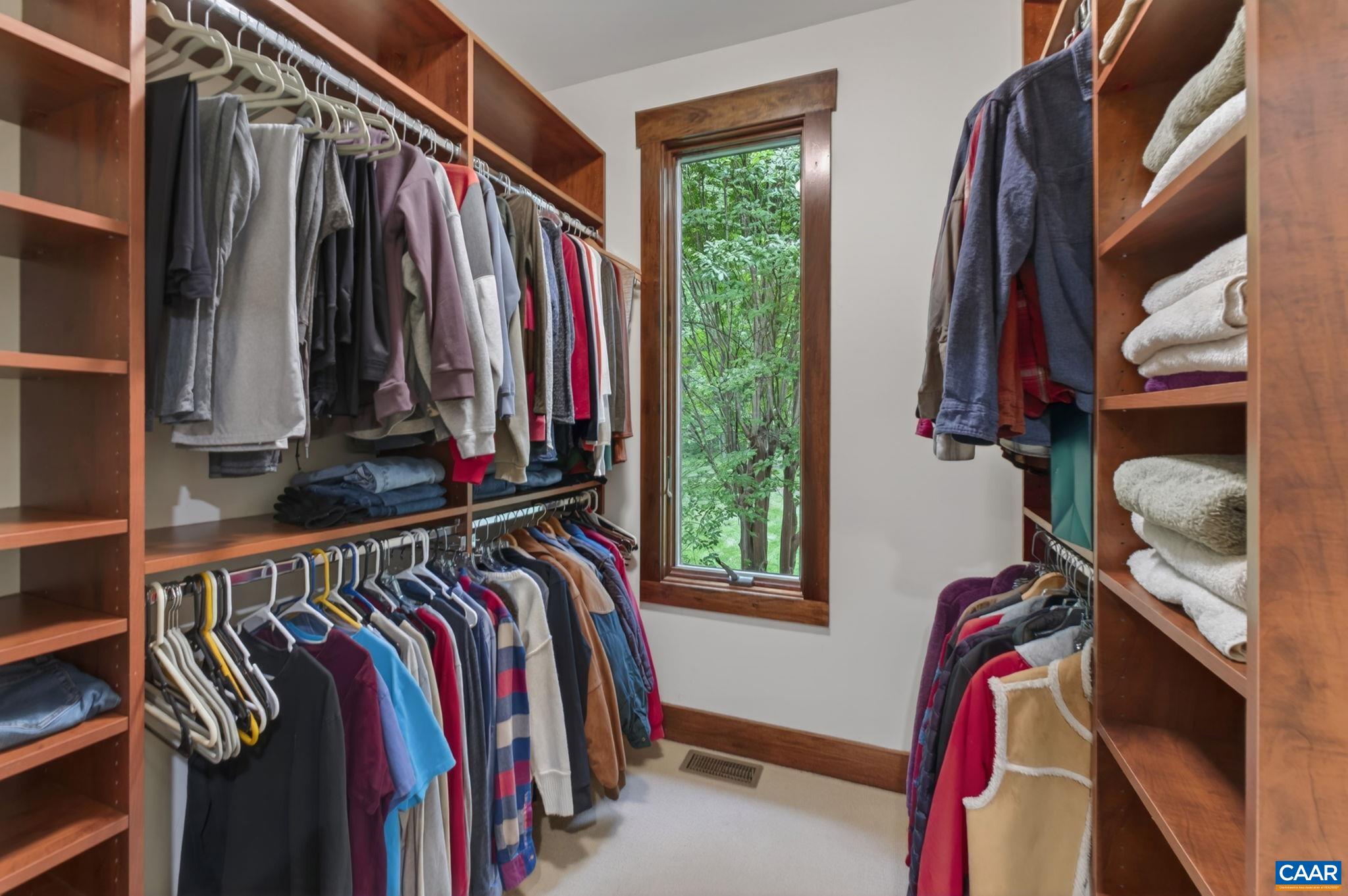 Primary walk-in closets with built-ins. Primary walk-in closets with built-ins.