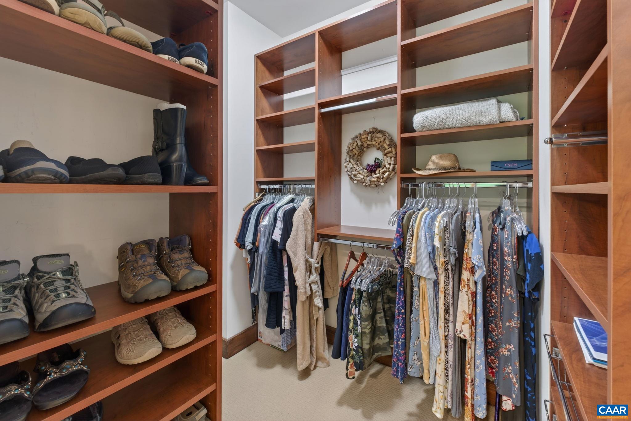 Primary closet with built-ins. Primary closet with built-ins.